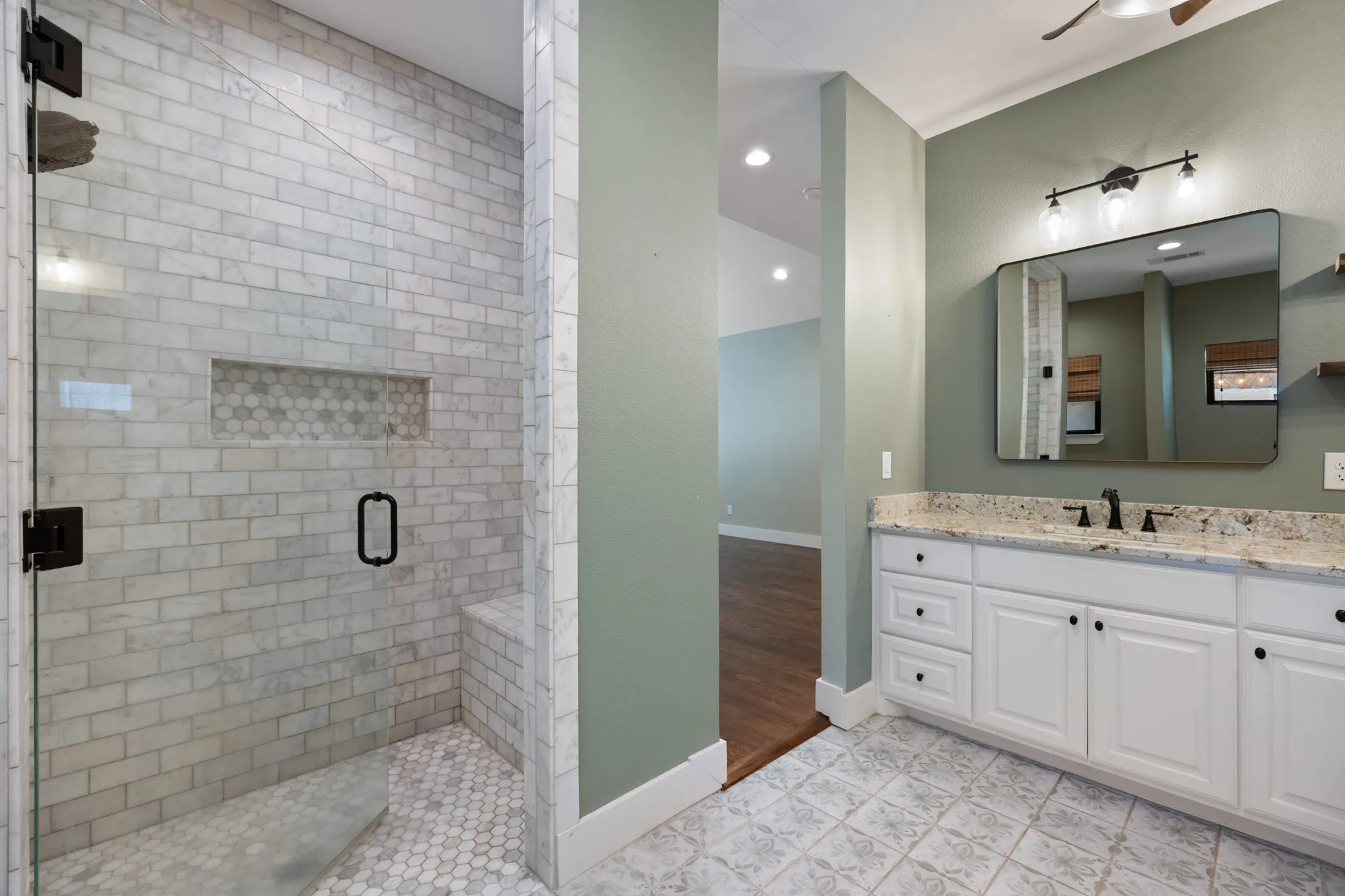 Primary Bathroom with Spa-Inspired Shower EnclosureLuxurious primary bathroom featuring a frameless glass shower enclosure with subway tile walls and mosaic tile flooring