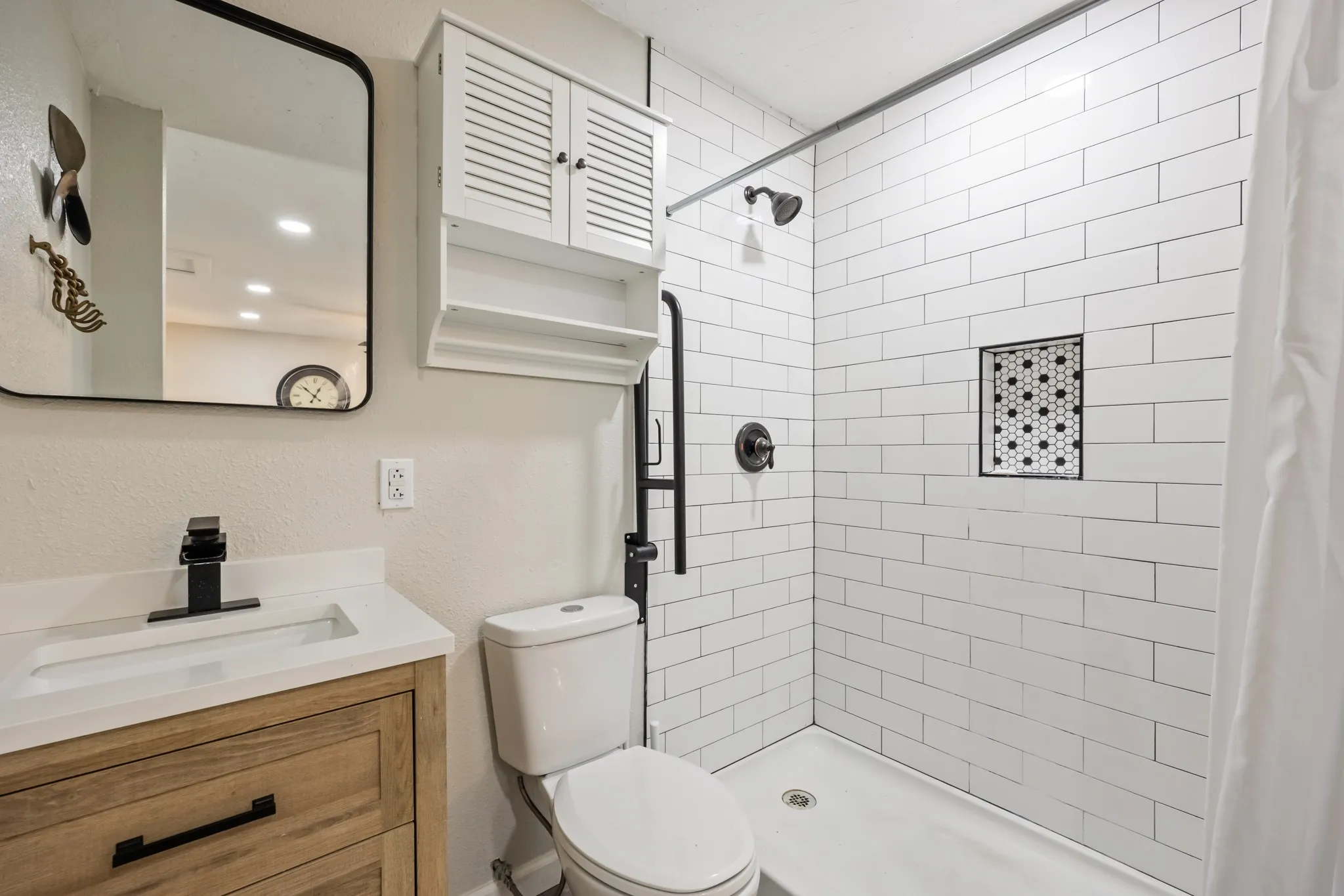 Wood-finish vanity with an integrated rectangular sink and matte black faucet