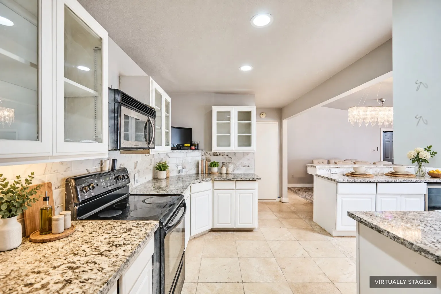 Kitchen featuring white cabinetry, granite countertops, tile flooring, and recessed lighting