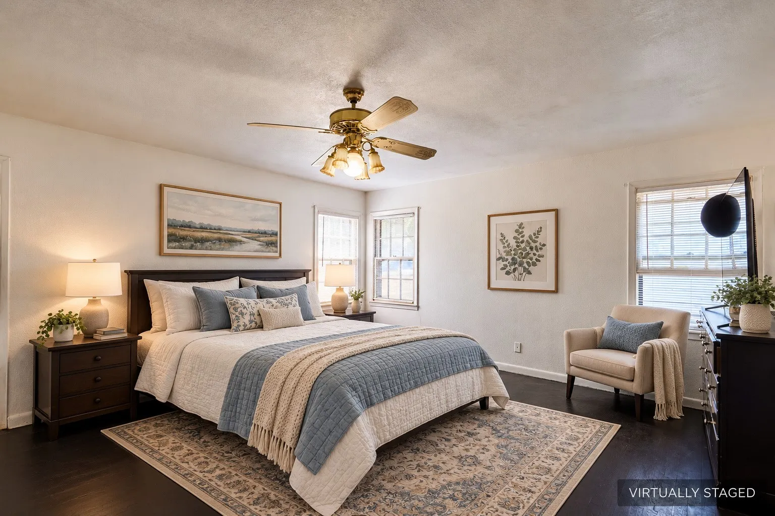 Dark wood-finish flooring, white walls, and a ceiling fan with integrated lighting
