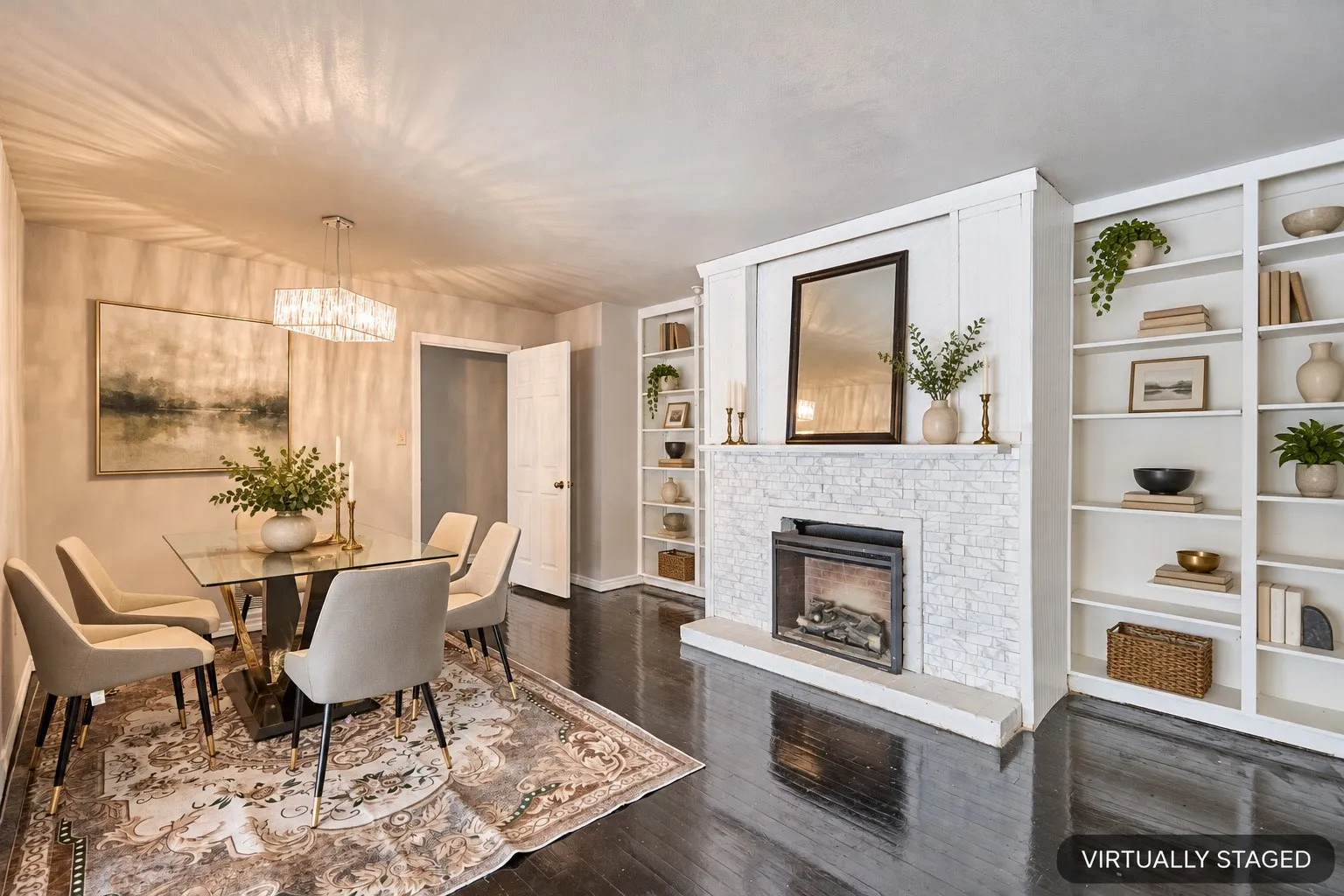 Dark wood-finish flooring, built-in shelving, stone-clad fireplace with mantel, and a rectangular chandelier