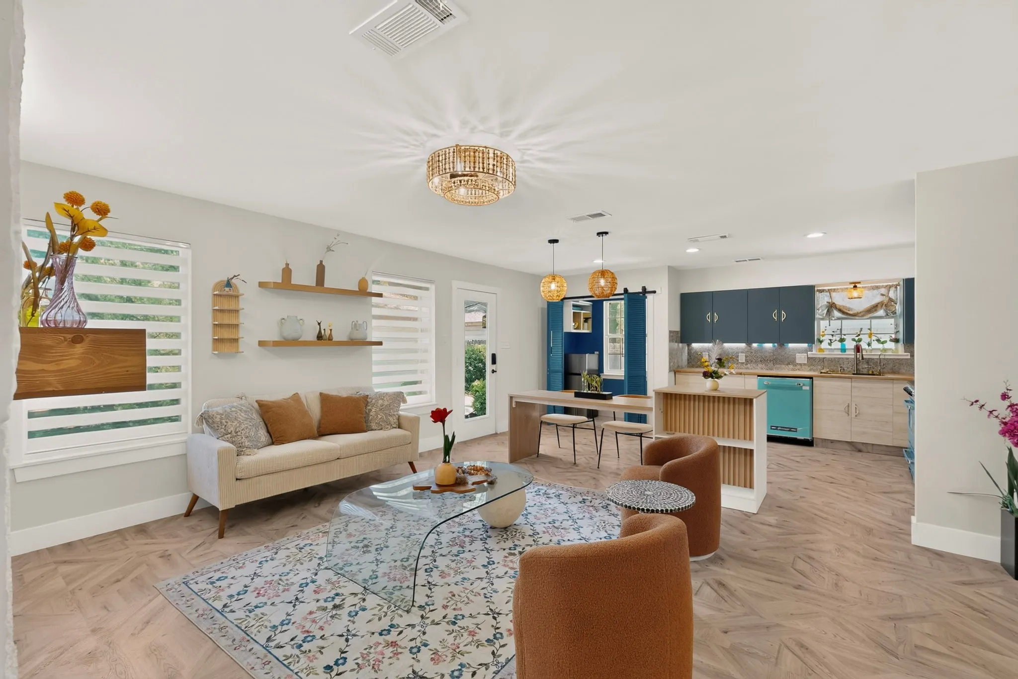 Open-concept living area with wood-finish flooring, a contemporary chandelier, and recessed lighting
