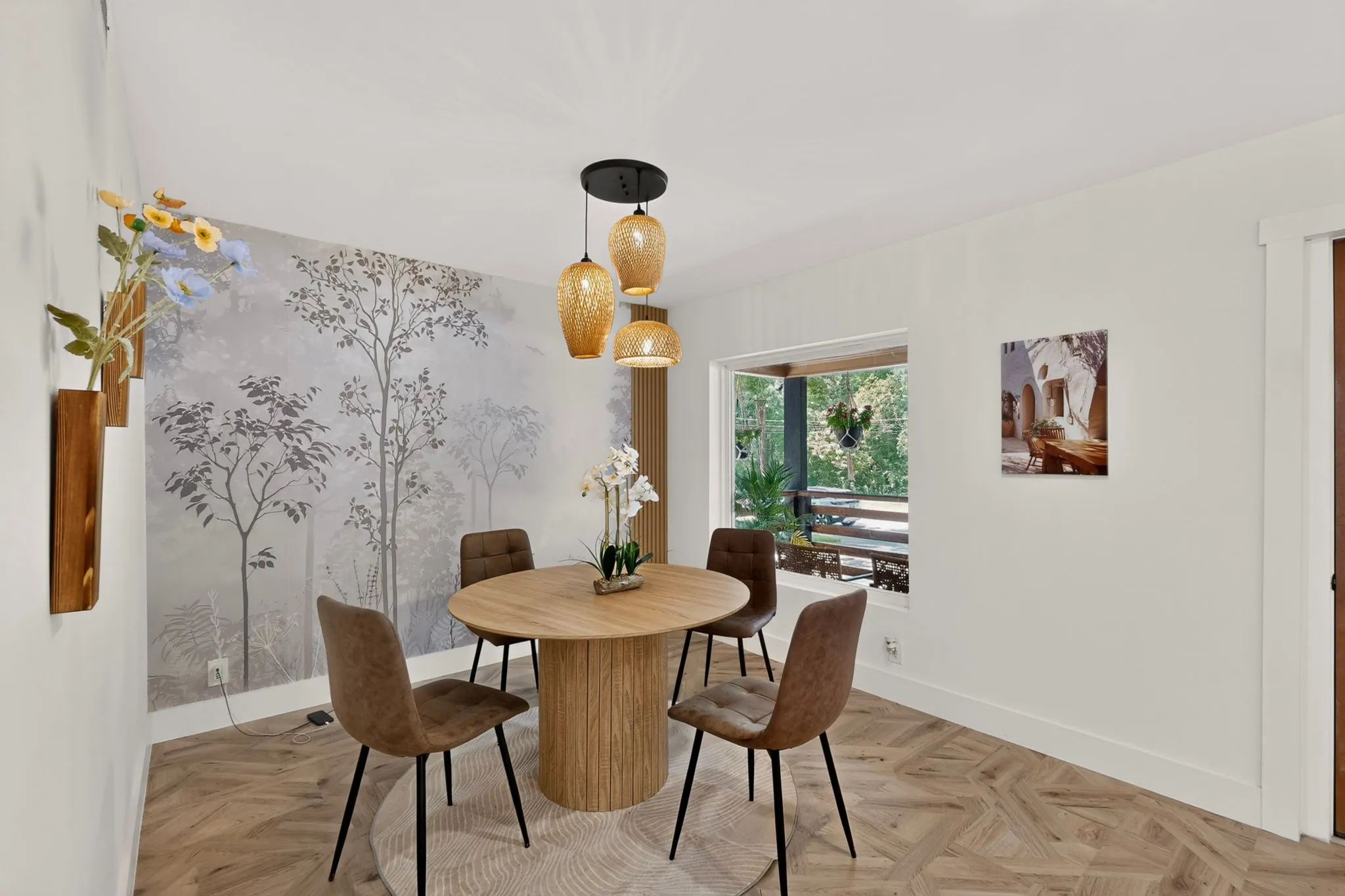 Dining area featuring wood-finish flooring, a decorative accent wall, and a large window