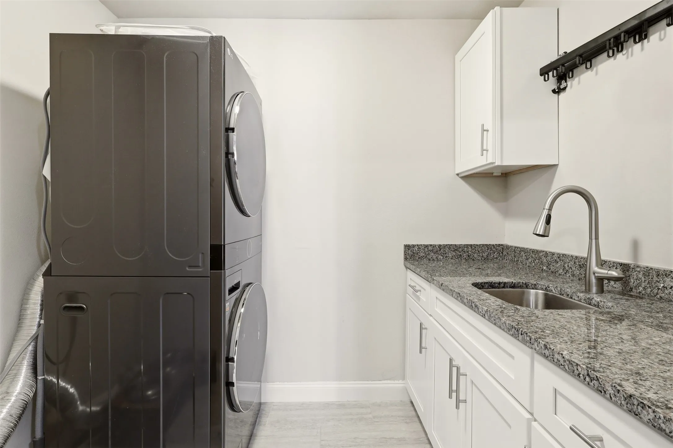 Spacious room featuring rich wood-finish flooring, recessed lighting, and a vaulted ceiling