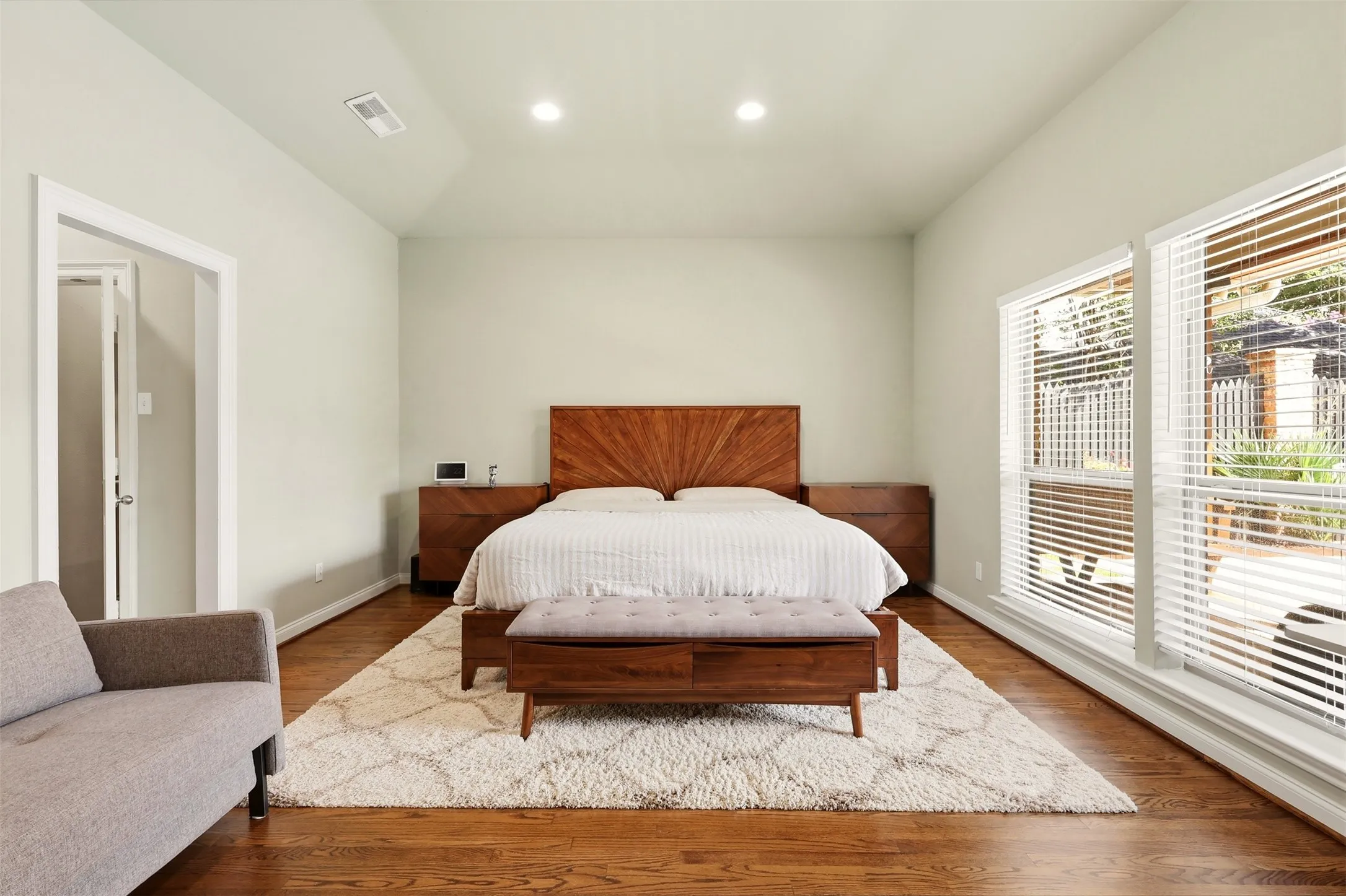 Spacious bedroom featuring wood-finish flooring and a vaulted ceiling