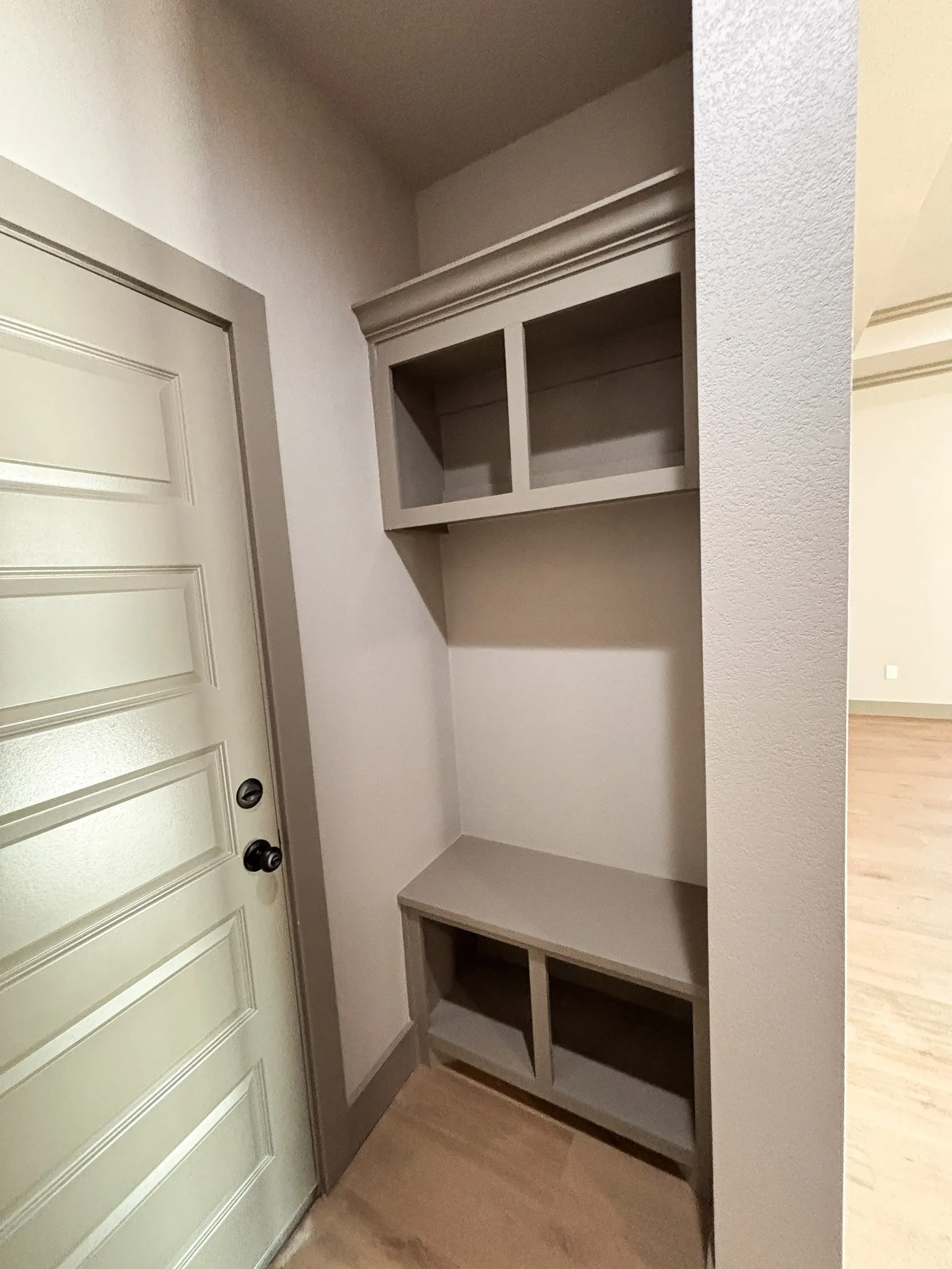 Built-in entry nook featuring upper cabinetry, a bench, and lower cubby storage
