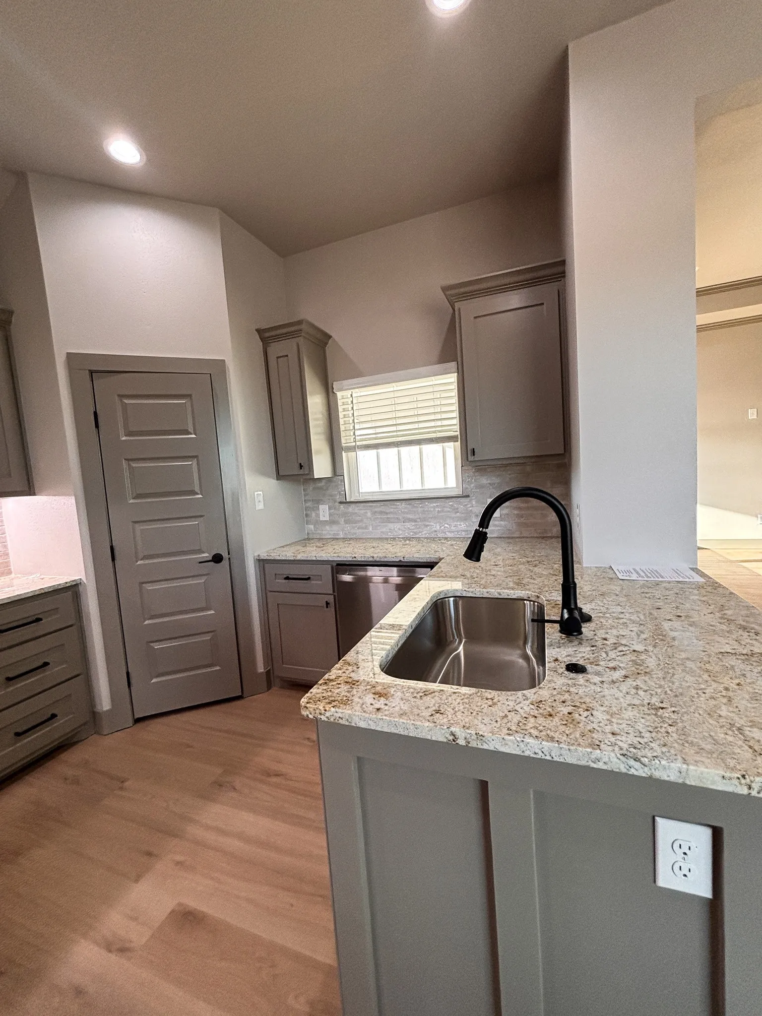 Kitchen featuring light wood-finish flooring, recessed lighting, and grey cabinetry