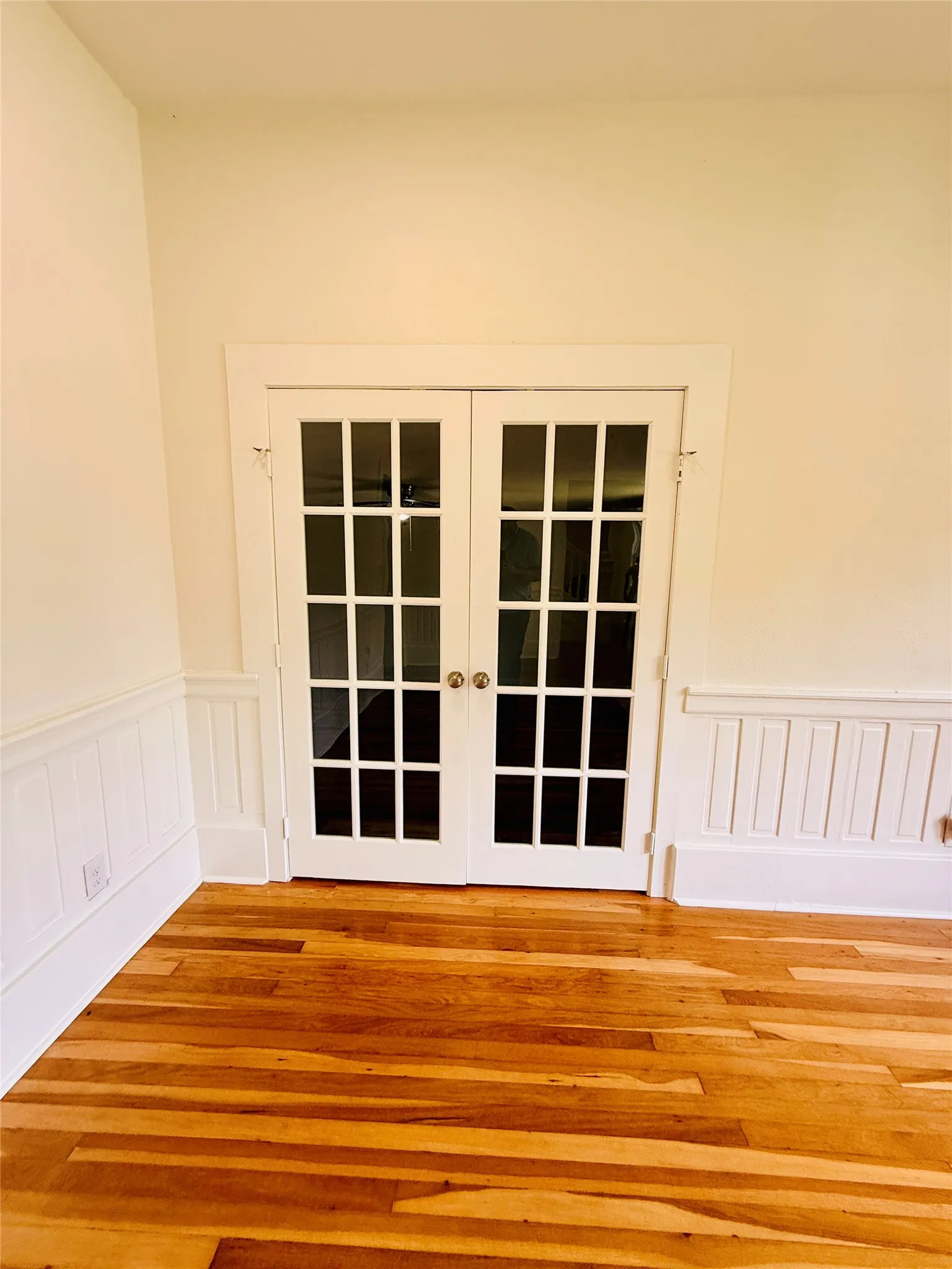 French doors into downstairs primary bedroom