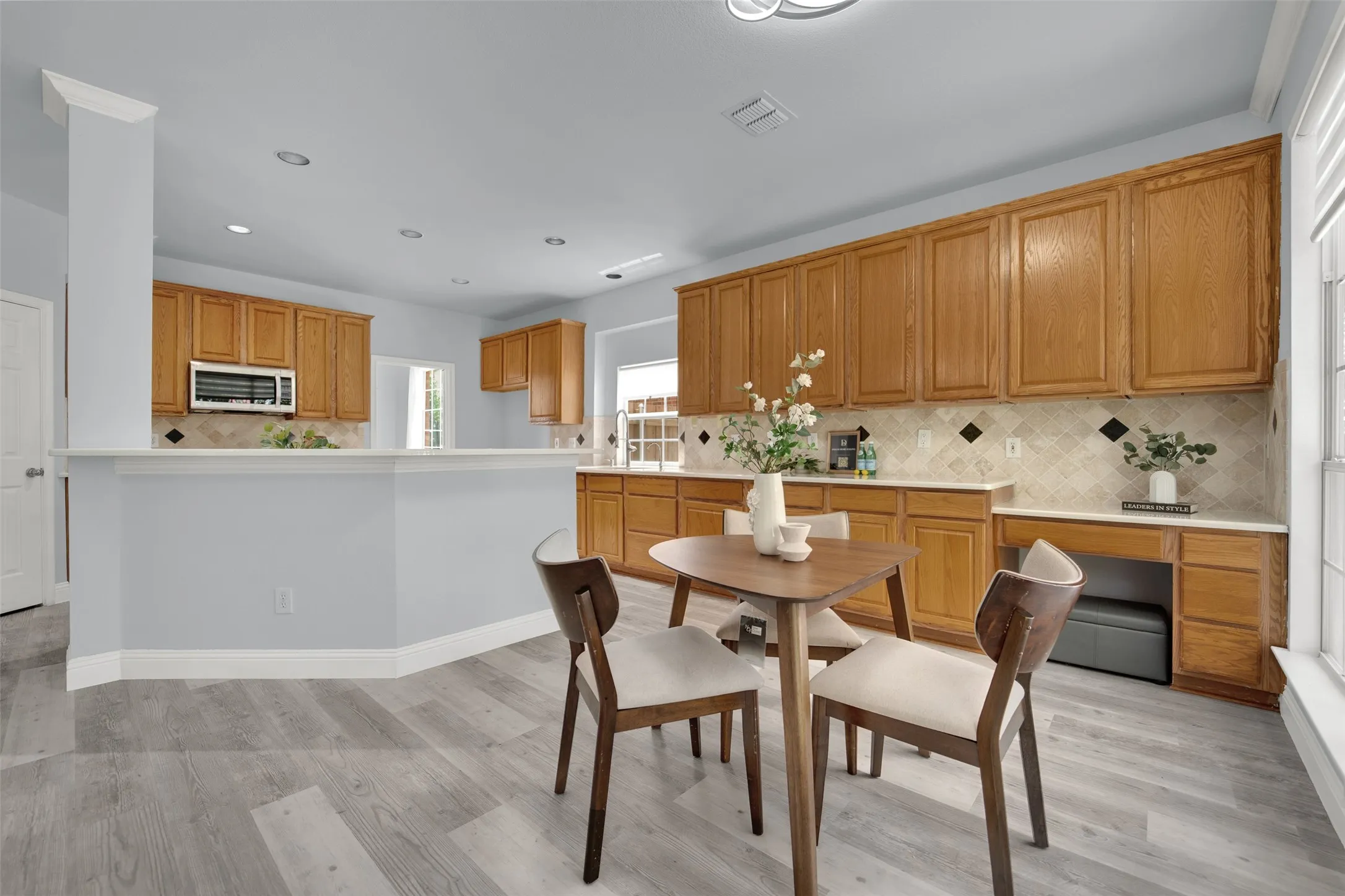 Light wood-finish flooring complements the light blue wall paint