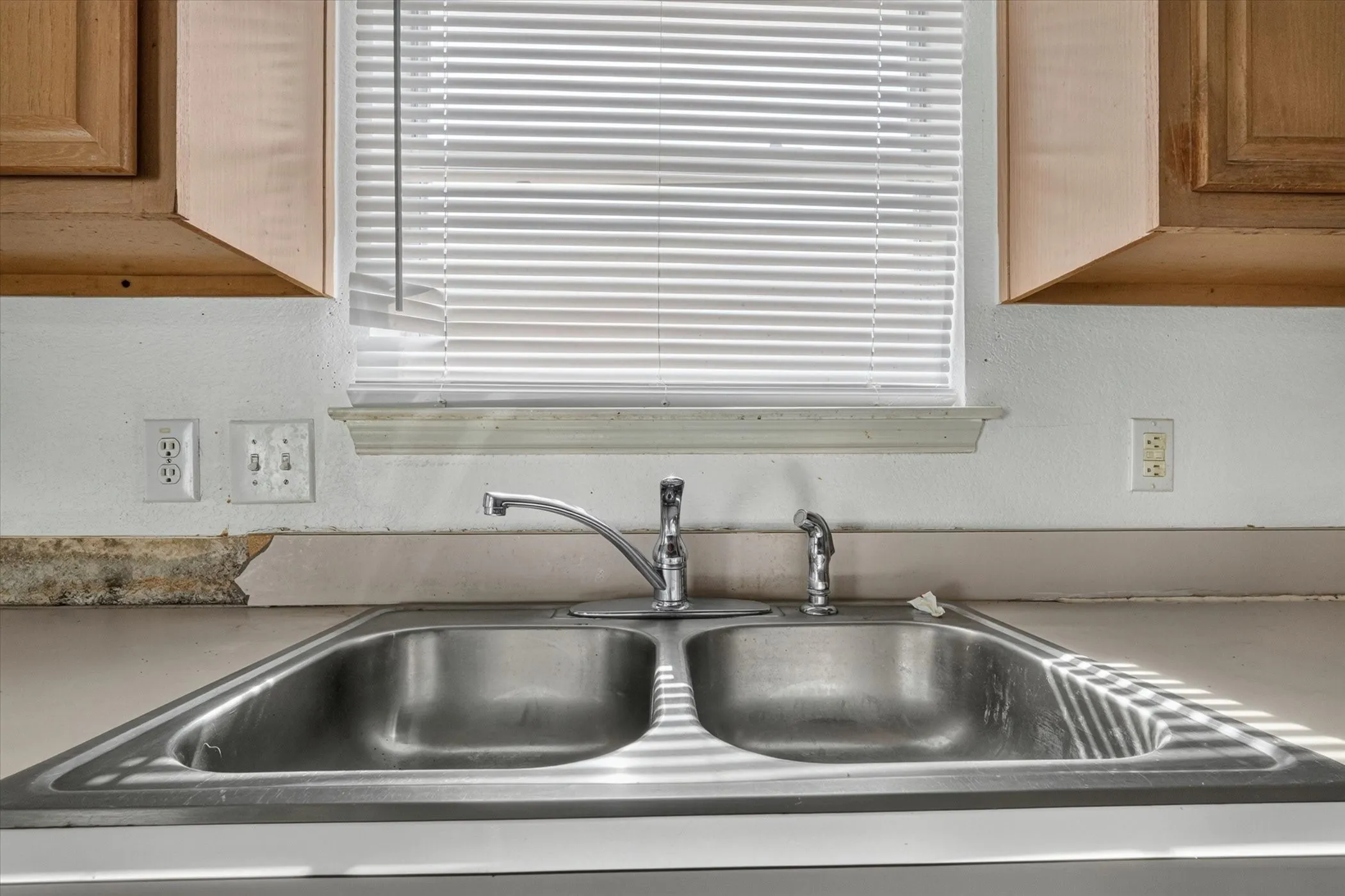Stainless steel double basin sink with a chrome faucet