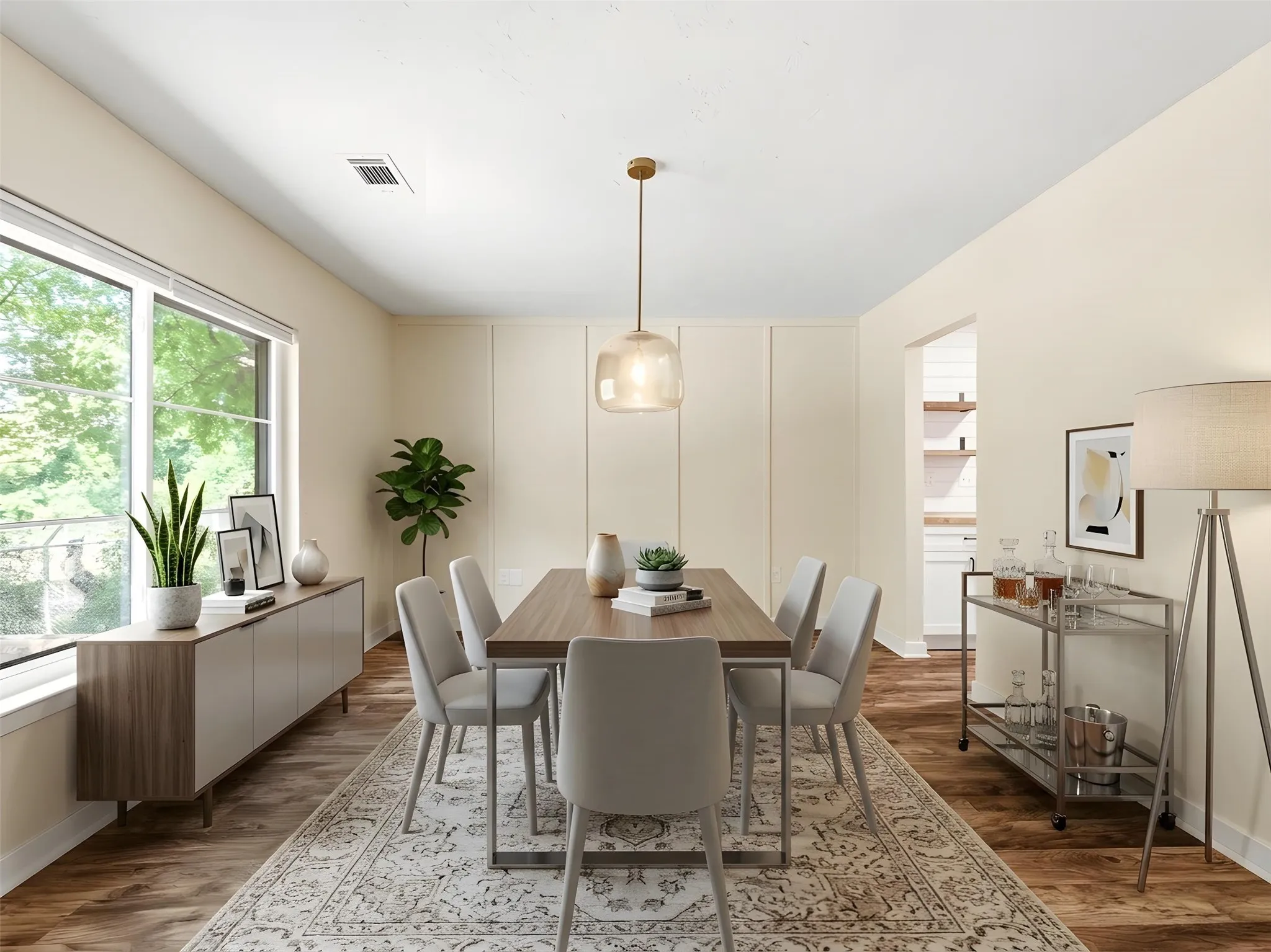 Dining area featuring wood-finish flooring, a large window, and light-toned walls