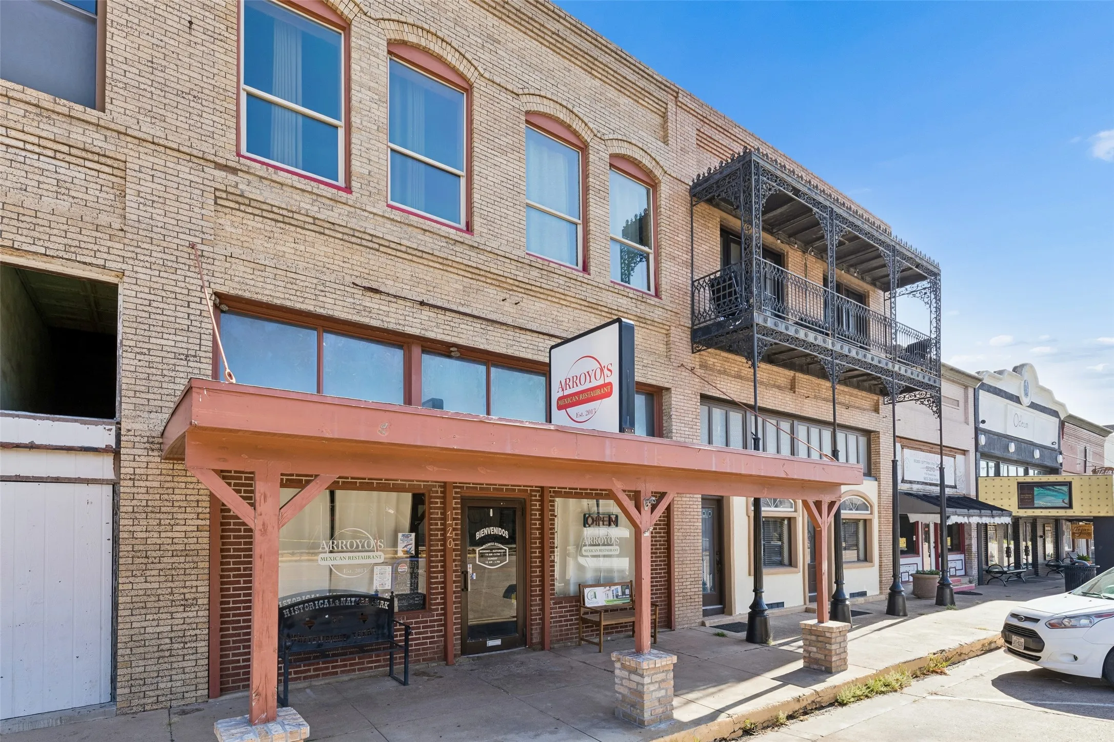 Brick facade commercial building with a ground-level storefront and second-story windows