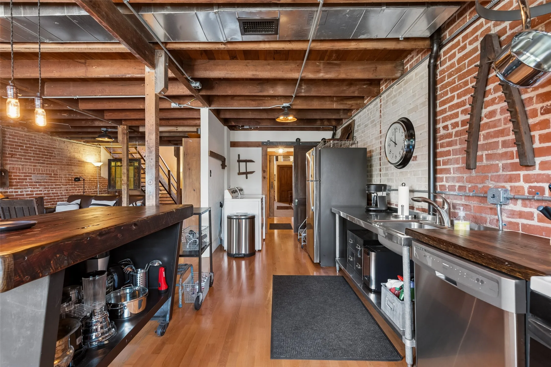 Exposed brick walls defining the kitchen and living areas