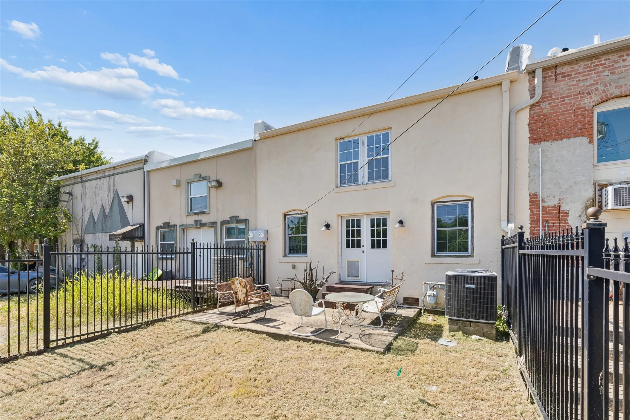 Rear exterior with stucco finish and multi-pane windows
