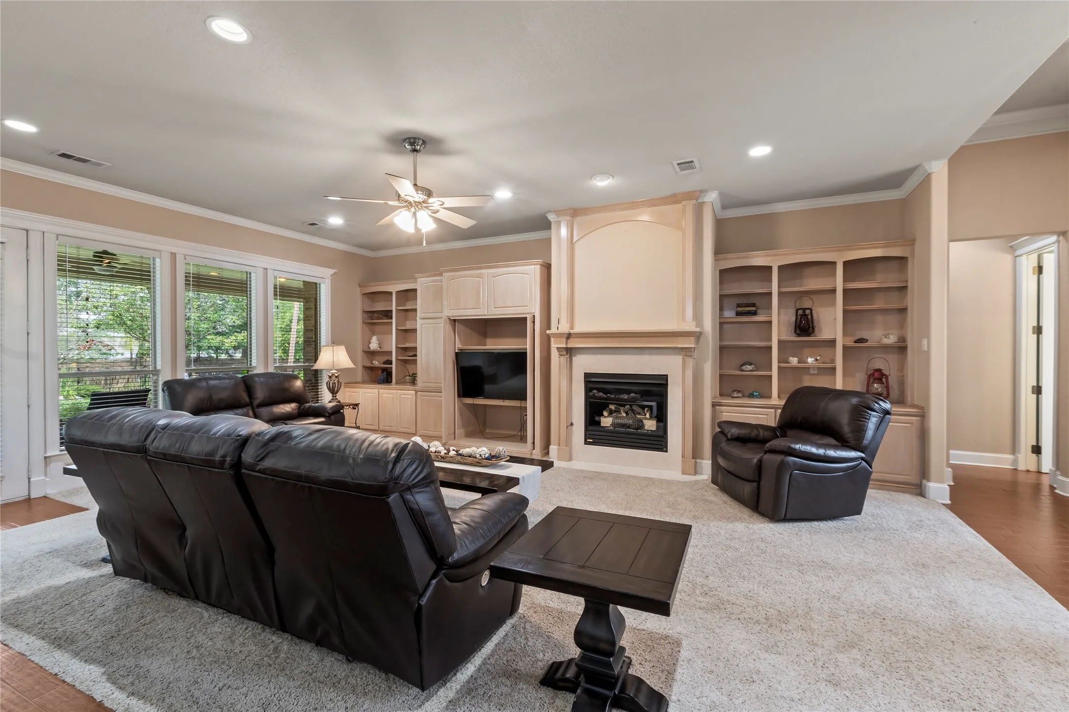 Living room with propane fireplace,reccessed lighting, and built in media storage