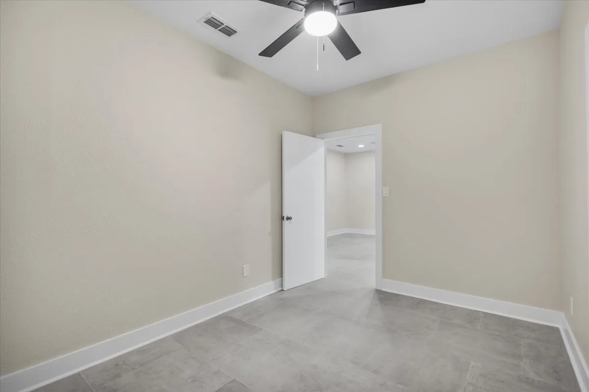 Neutral wall tones complement the tile flooring
