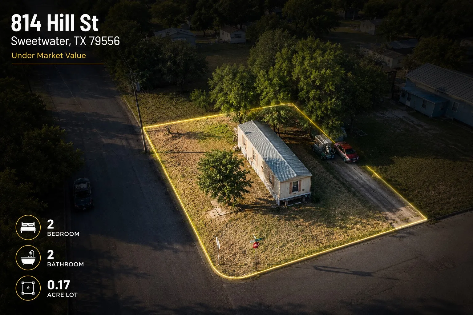 High-angle aerial shot showcasing the corner lot position, tree shade, and surrounding neighborhood context.