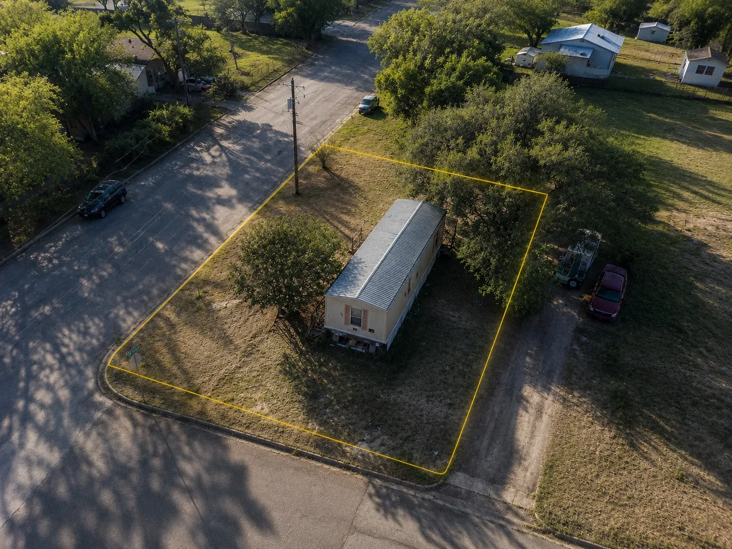 Elevated view showing rear property line, side yard space, and quiet street setting.