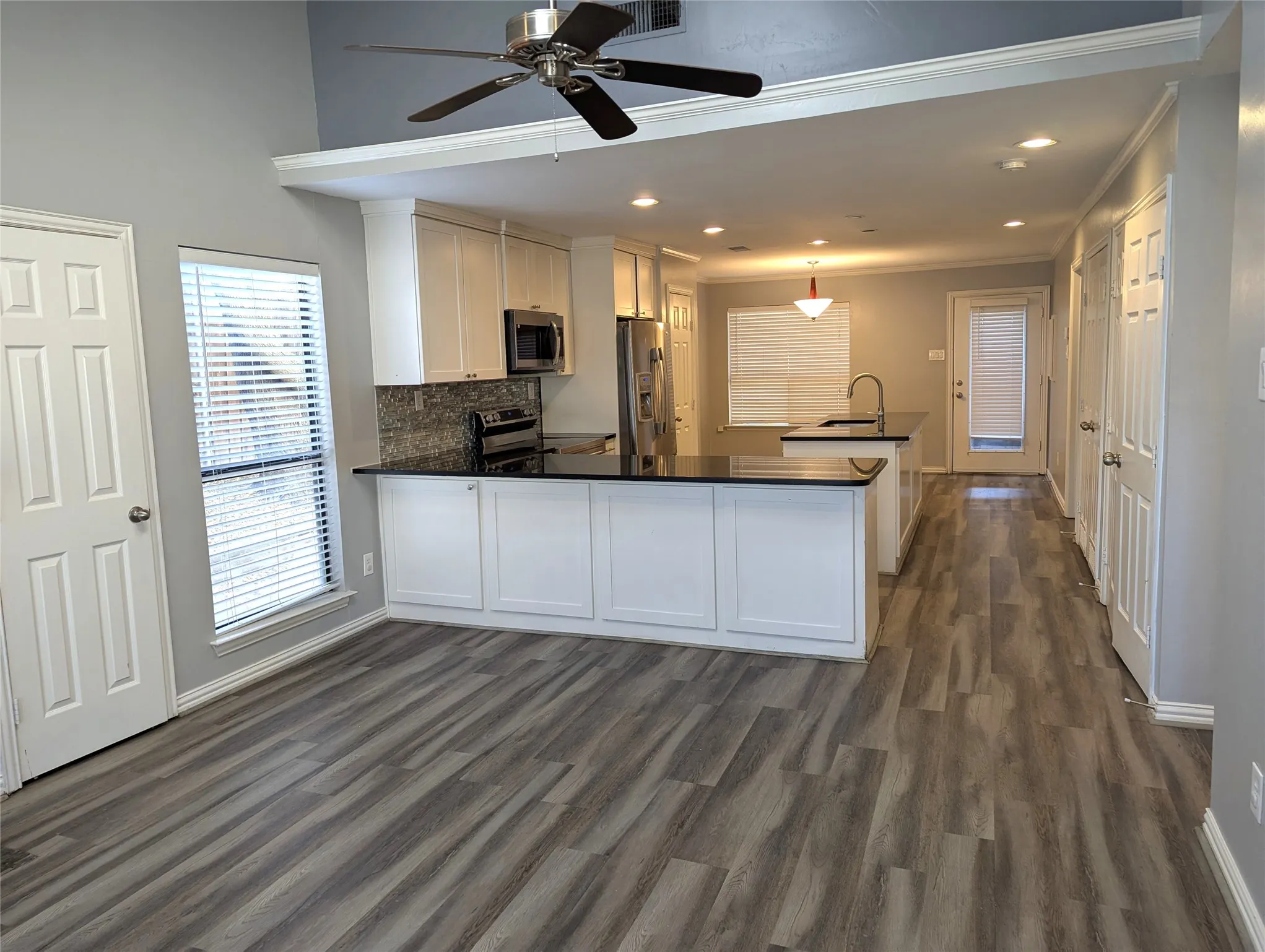Open-concept living space with wood-finish flooring
