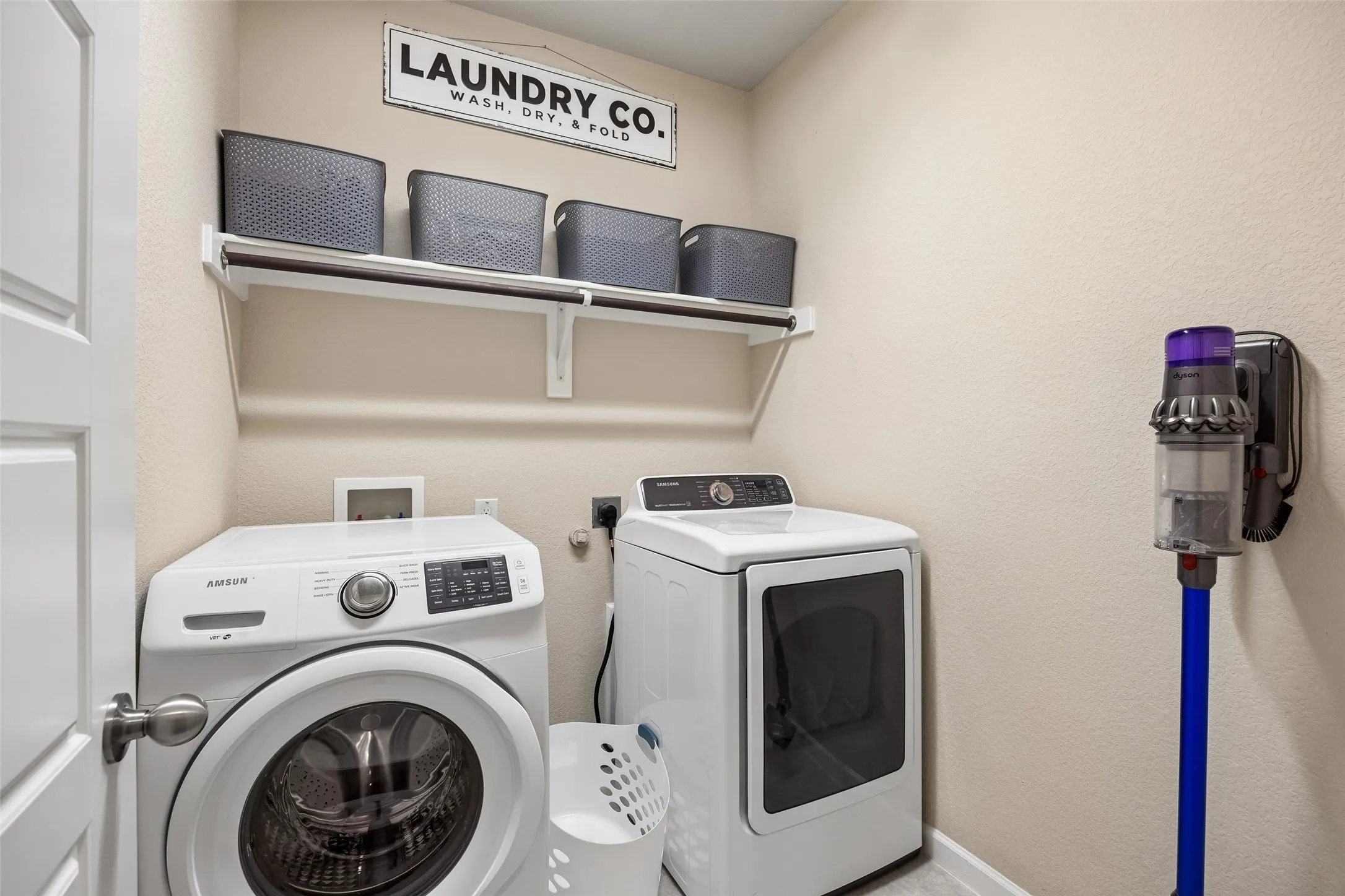 Laundry space featuring open storage shelves