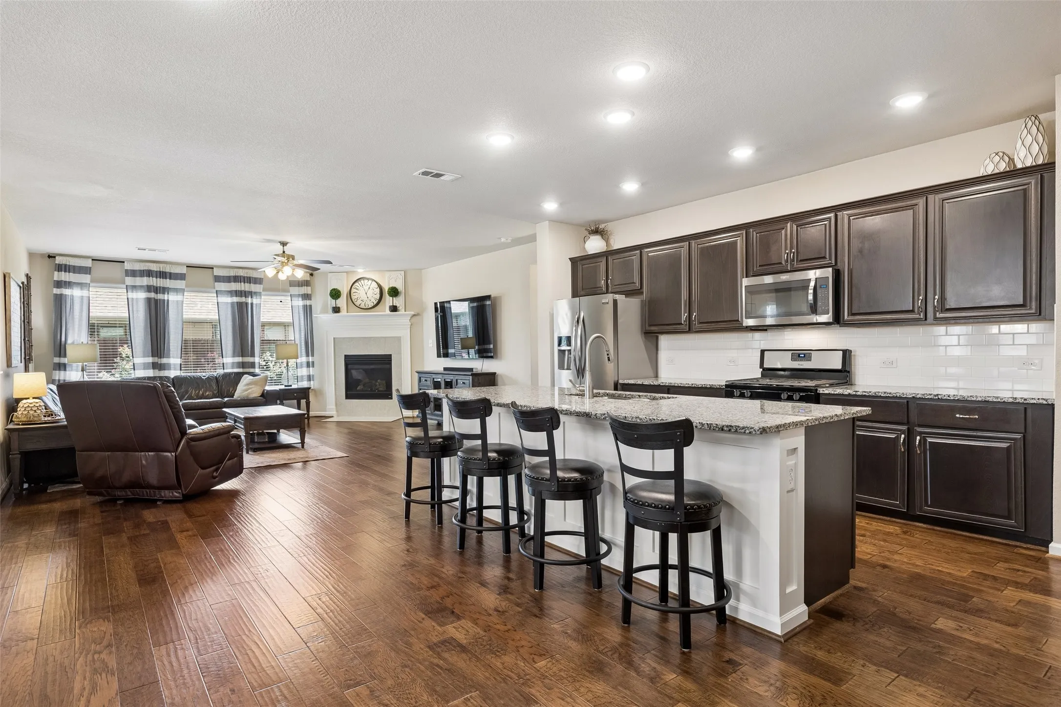 Open-concept living area and kitchen featuring a kitchen island with seating