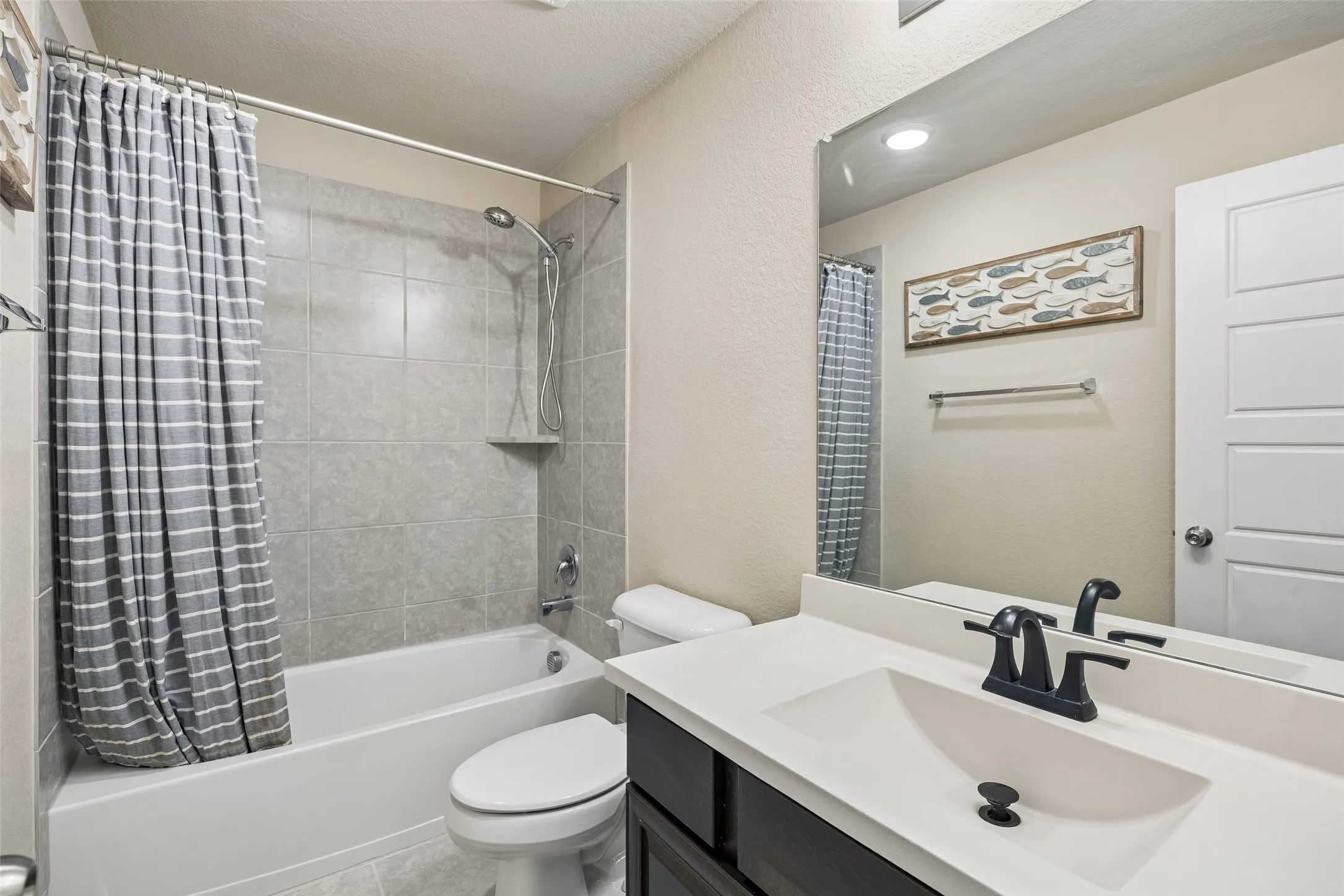 Full bathroom upstairs has a tub-shower combo