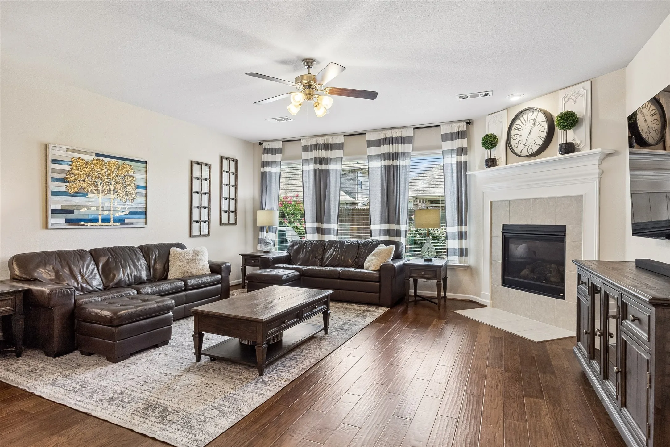 The living area features multiple windows with blinds