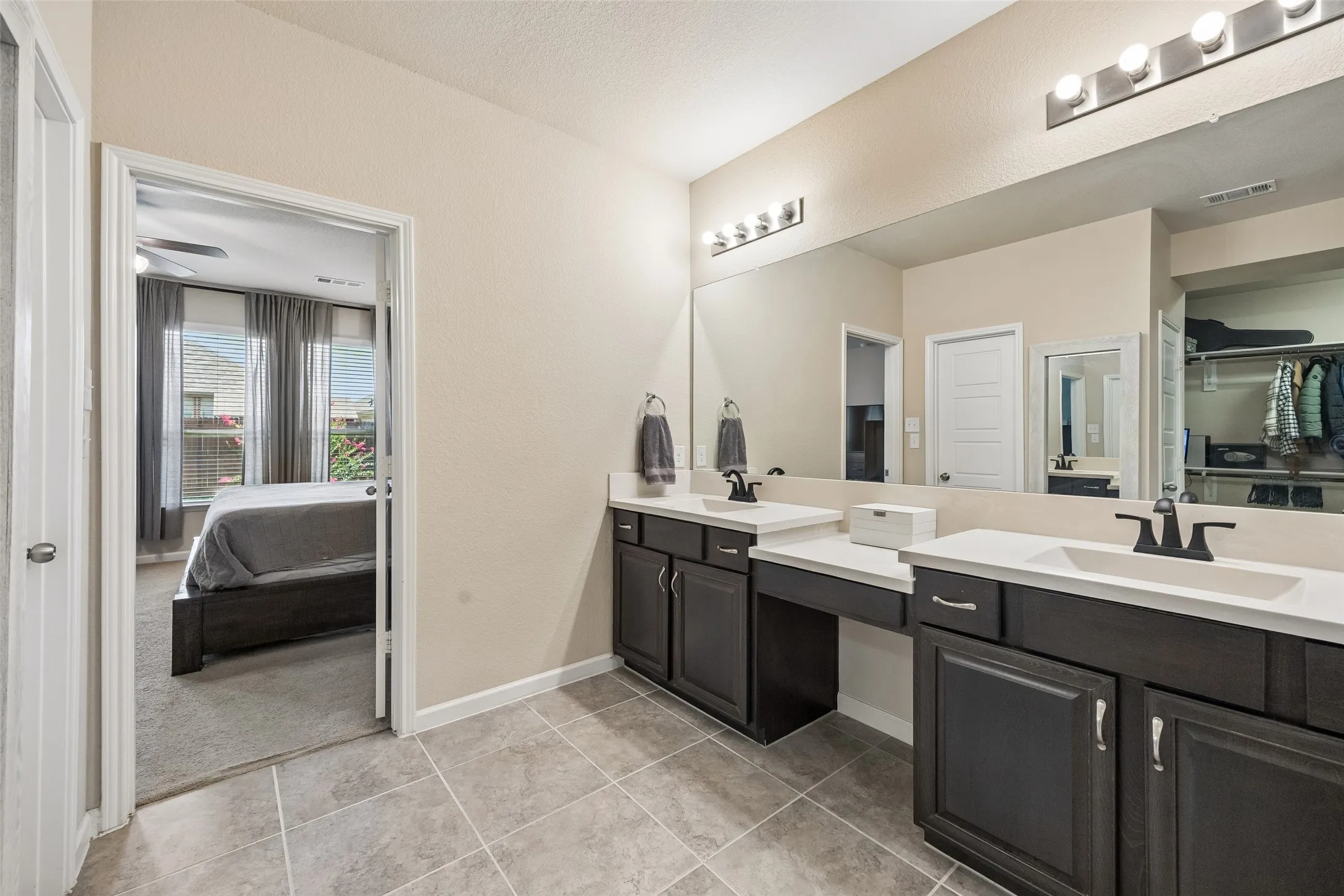 The large vanity features 2 sinks and a lower vanity sitting area.