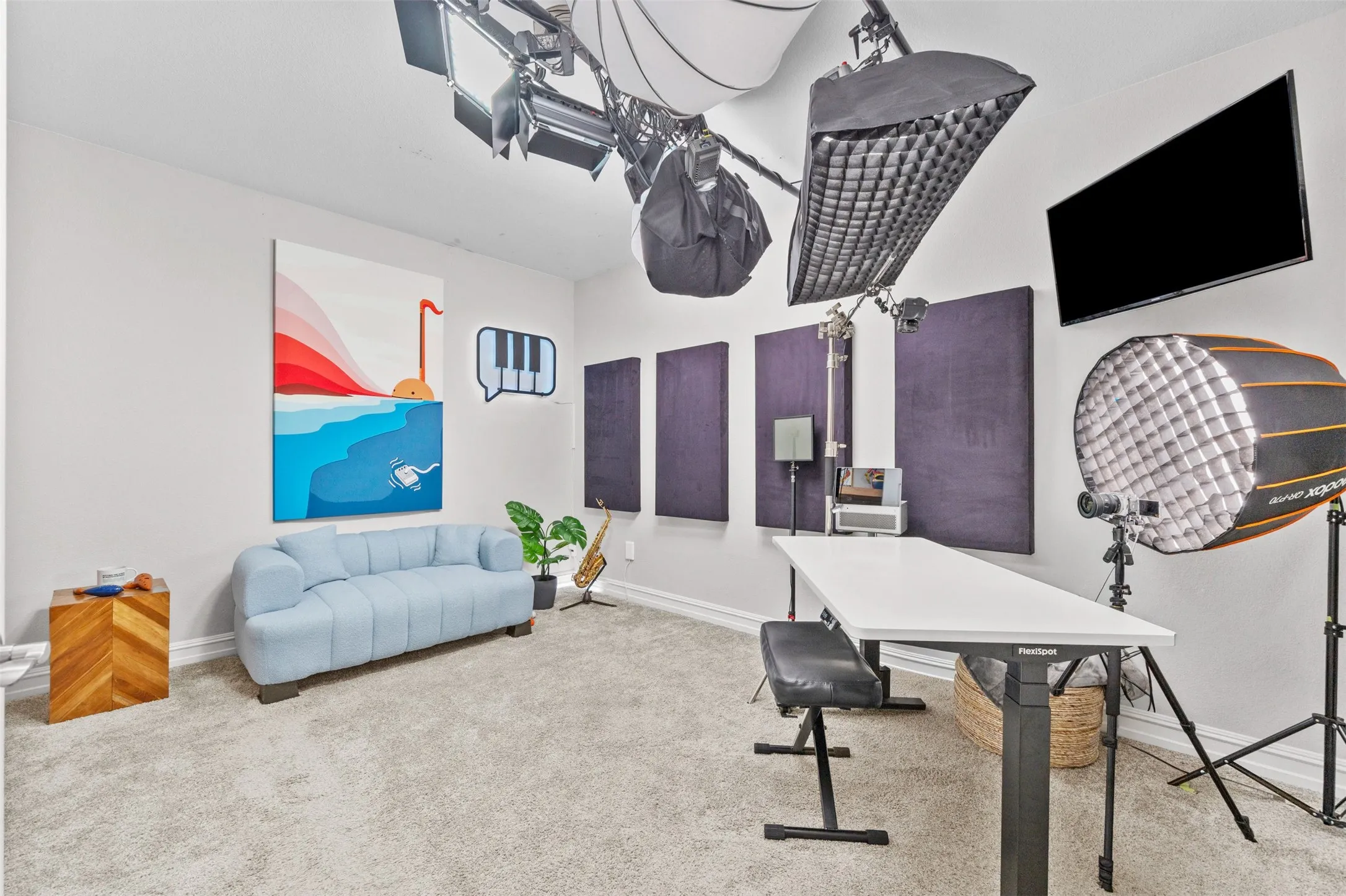 Spacious room featuring light gray carpeting, neutral wall finishes, and ceiling-mounted lighting fixtures