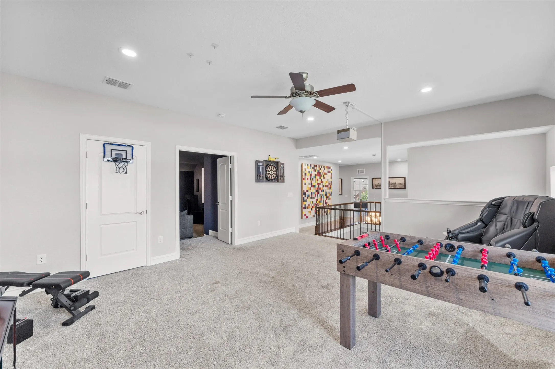 Spacious carpeted bonus room featuring recessed lighting, a ceiling fan, and an open railing overlooking the level below