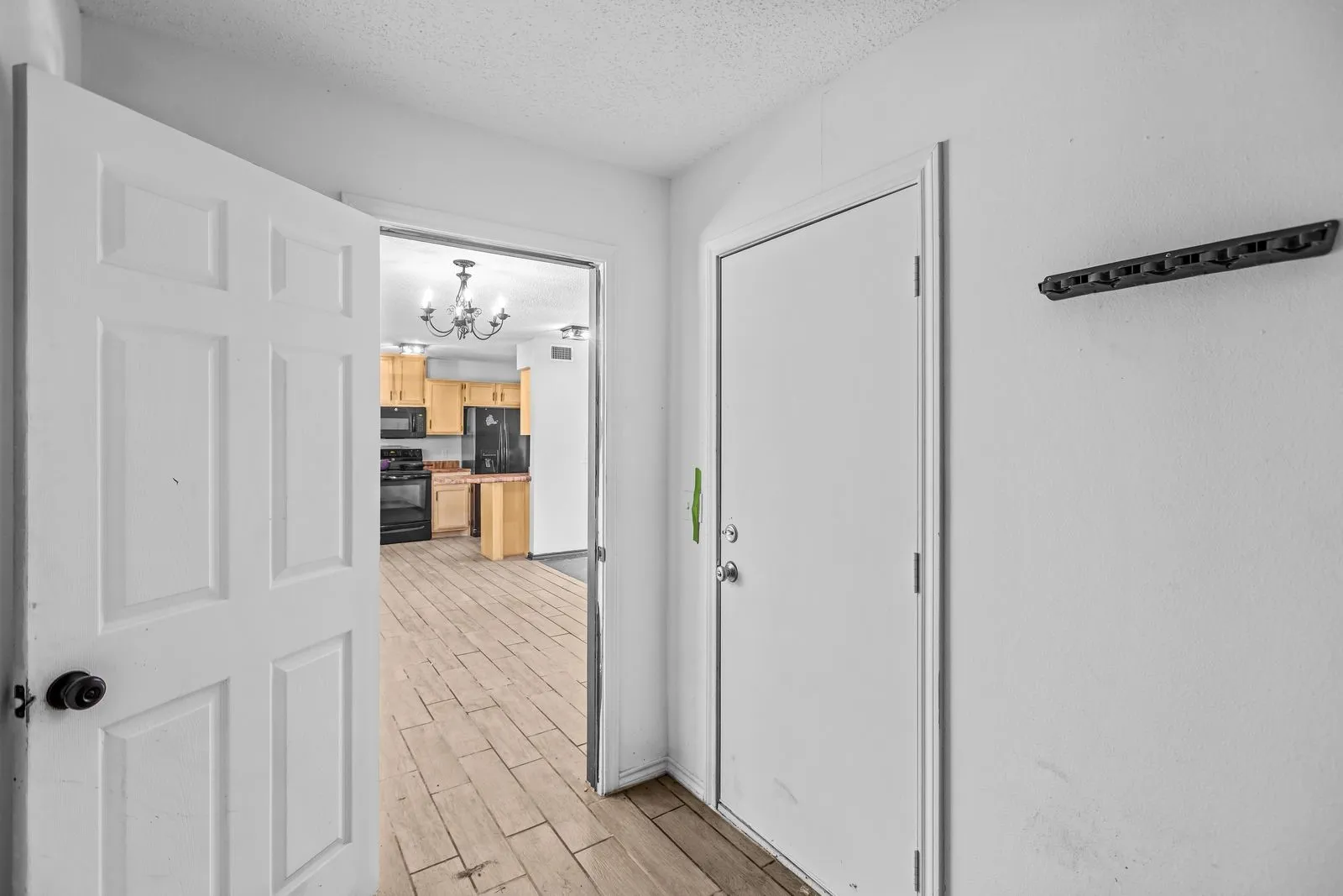 Laundry room attached to garage and leading to dining