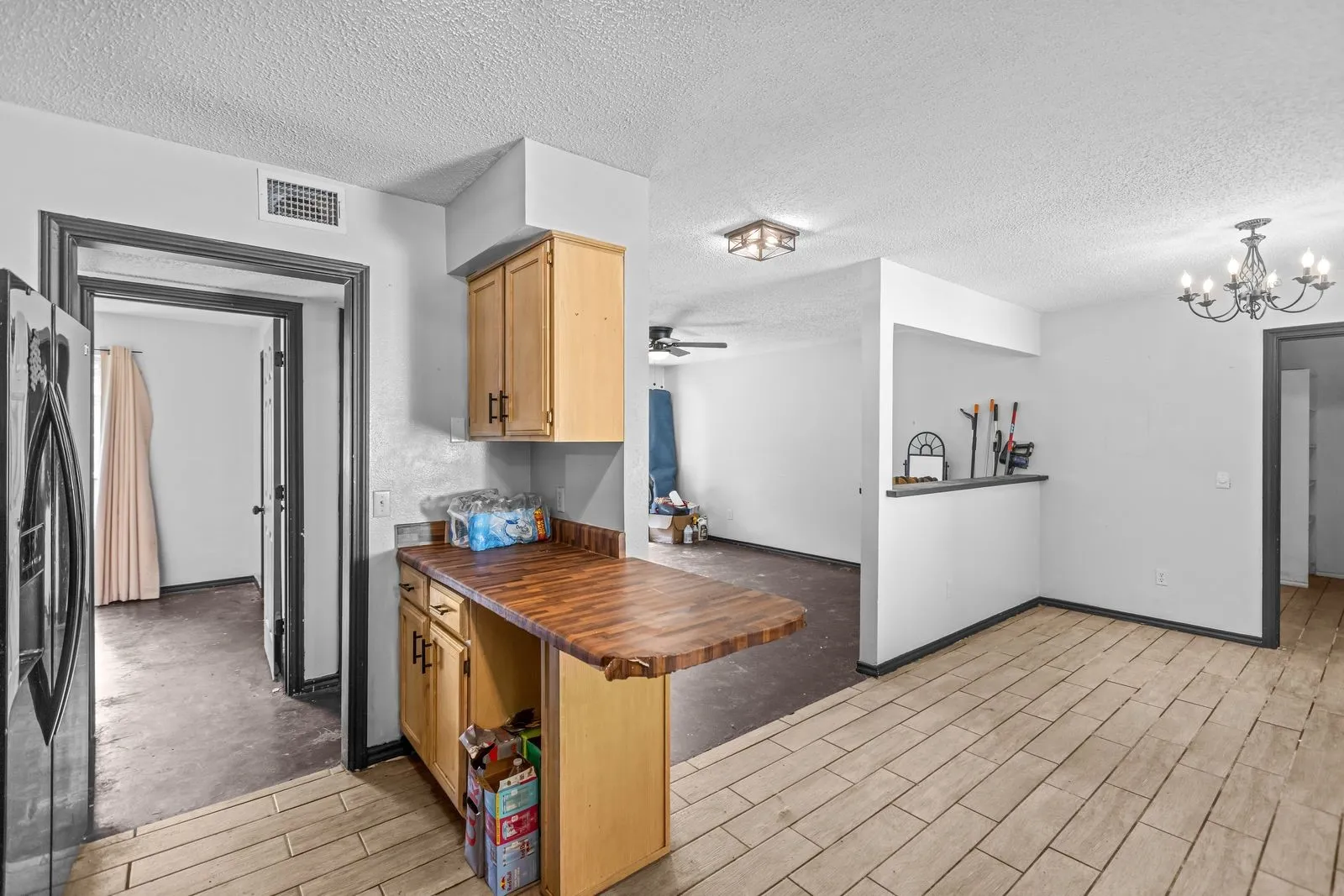 Kitchen with light wood cabinetry and a wood-finish countertop