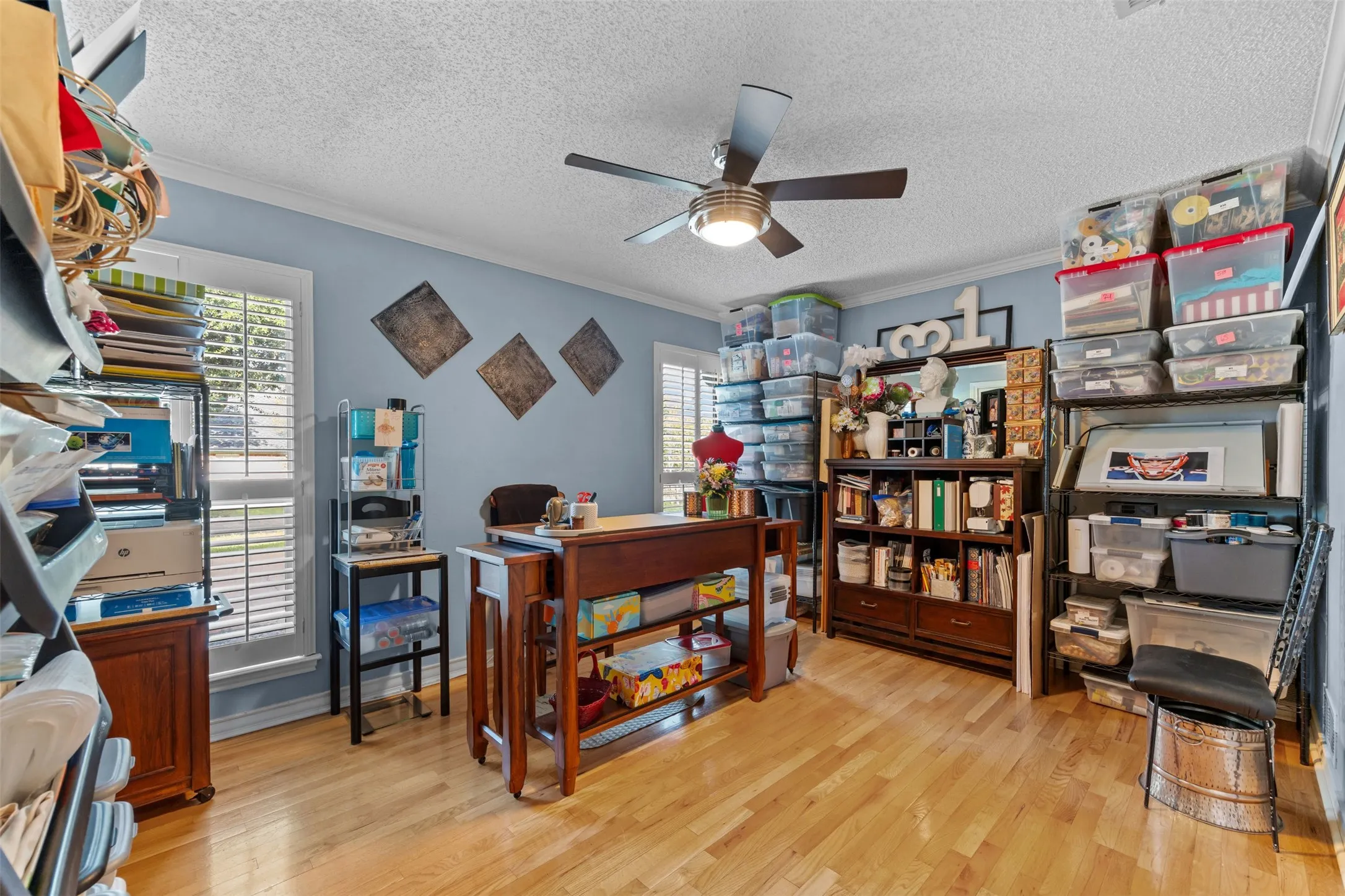 Versatile room featuring wood-finish flooring, light blue wall paint, and white trim
