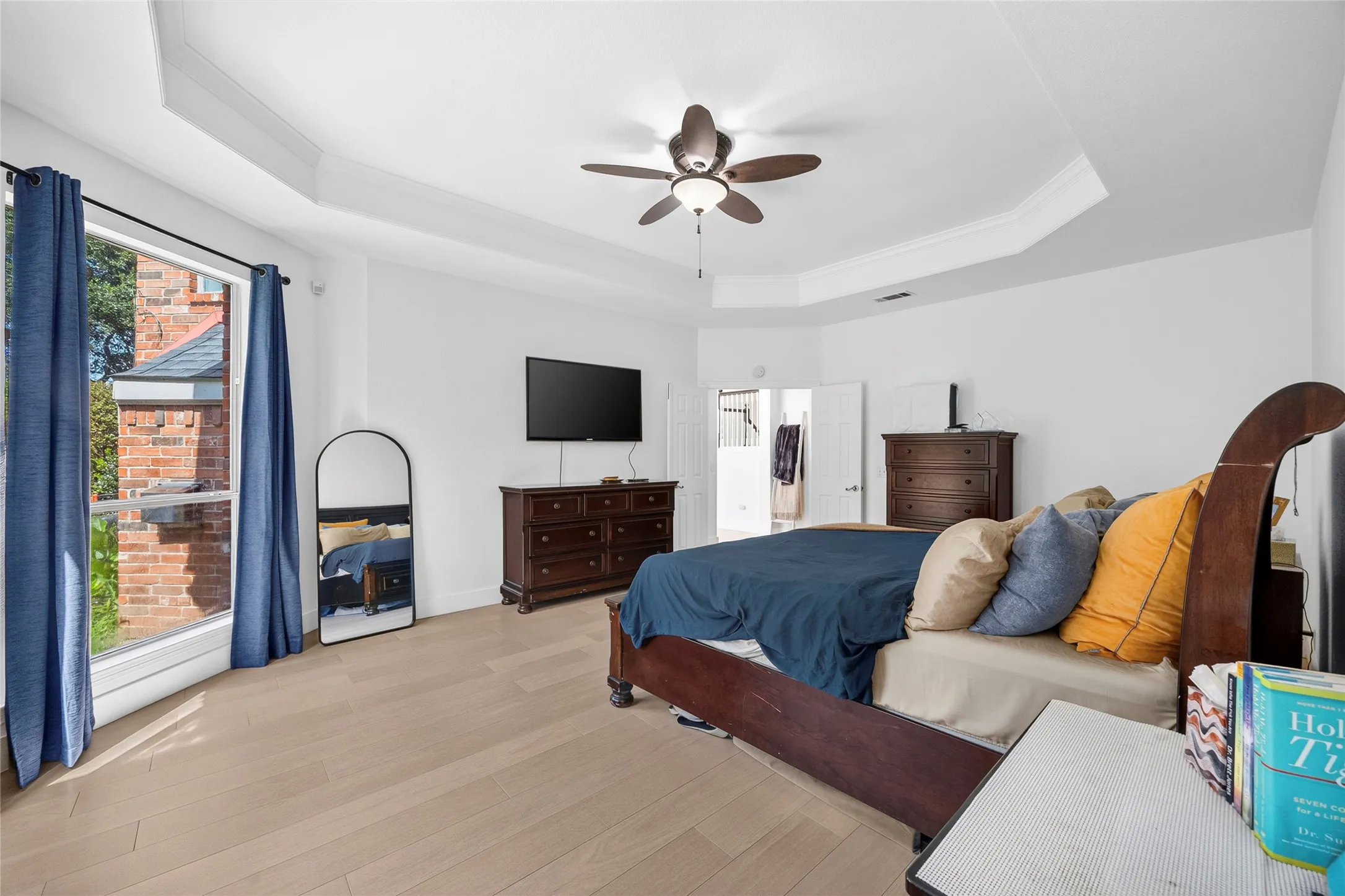 ceiling fan and tv plus room for sitting area