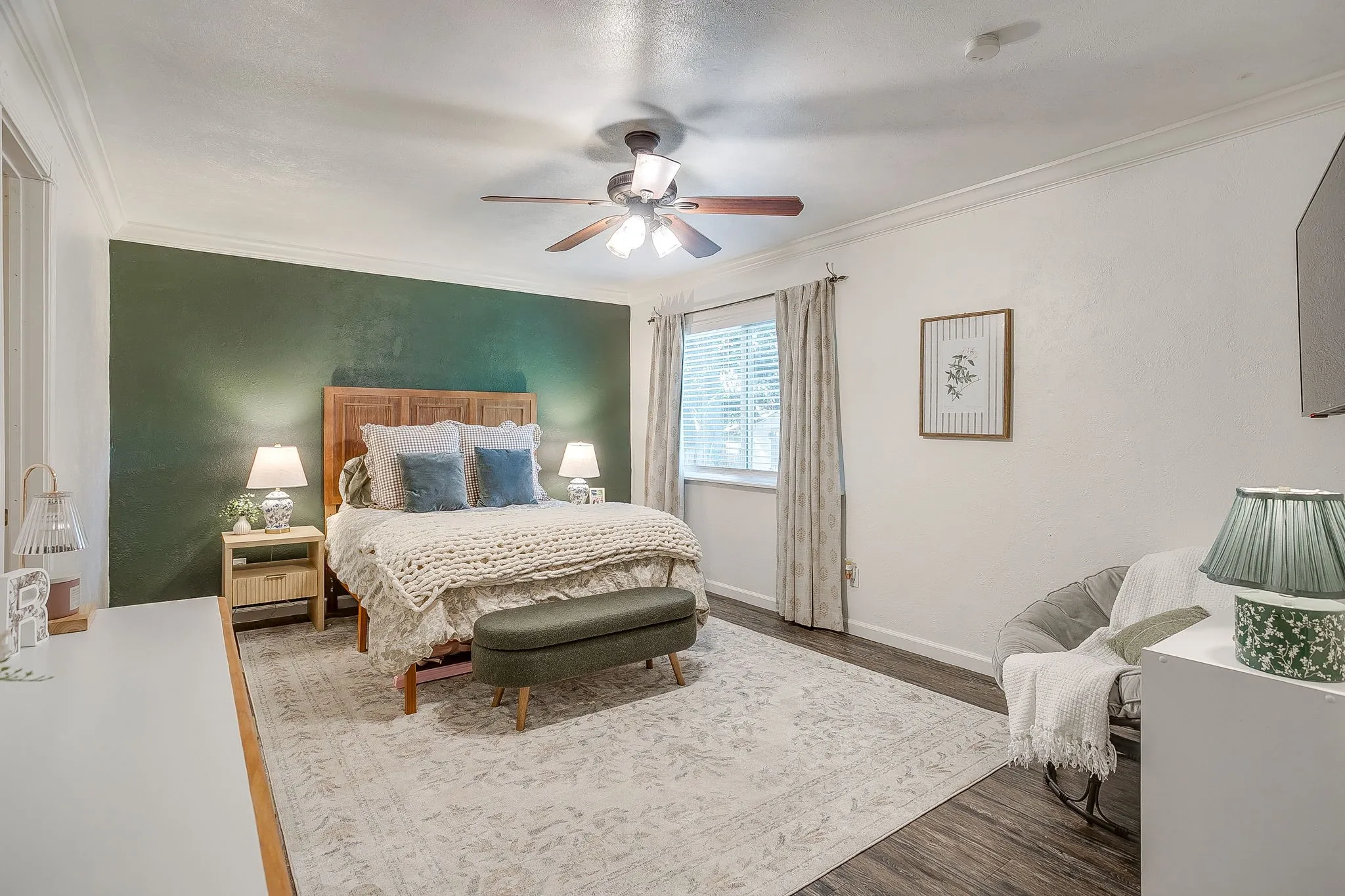 Primary bedroom oversized with accent wall and sitting space.