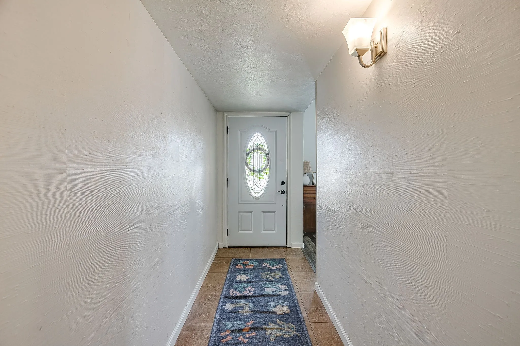 Lovely light and bright living room with vaulted ceiling, fresh paint, and laminate flooring.