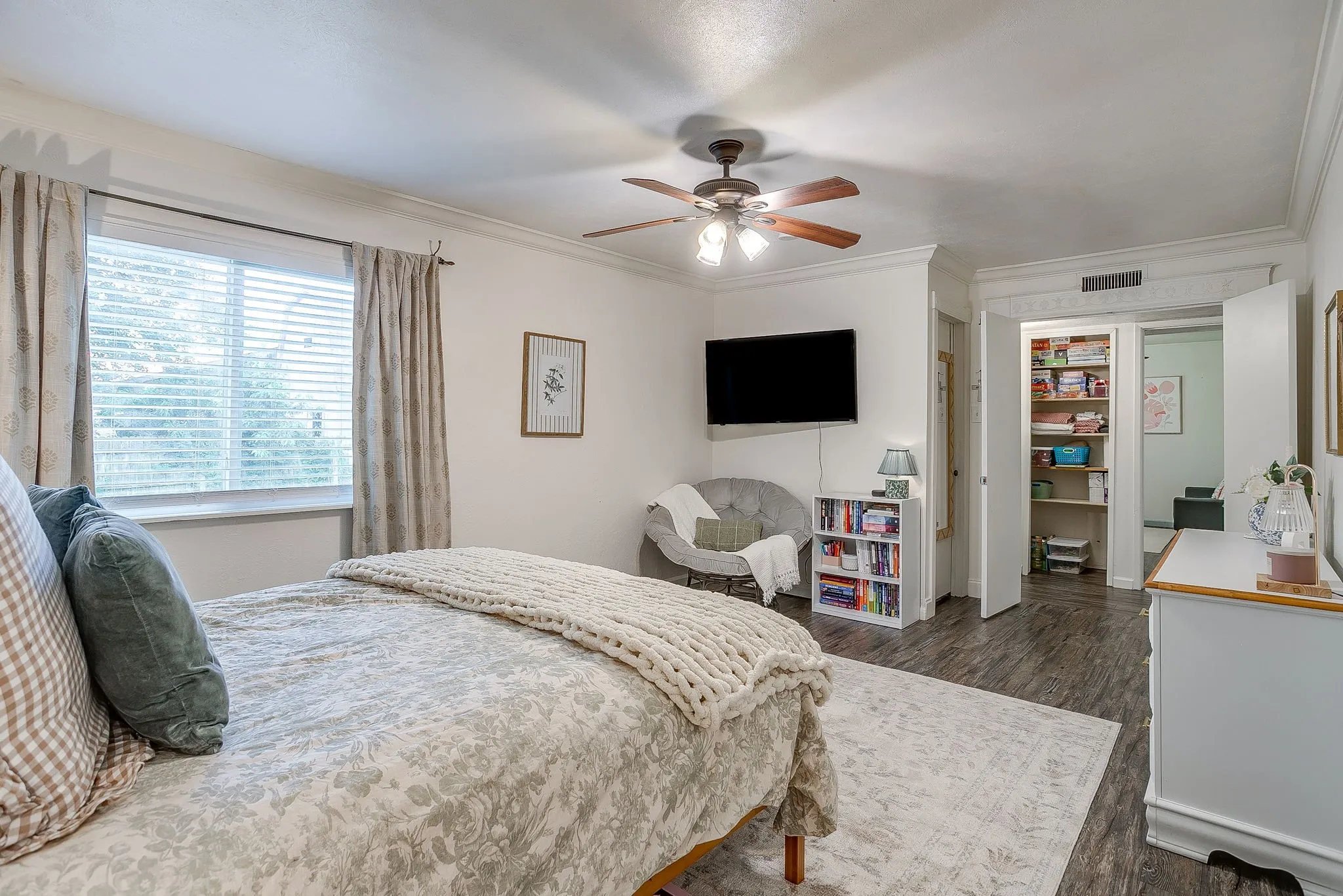 Oversized primary suite with double doors, walk in closet and sitting area.