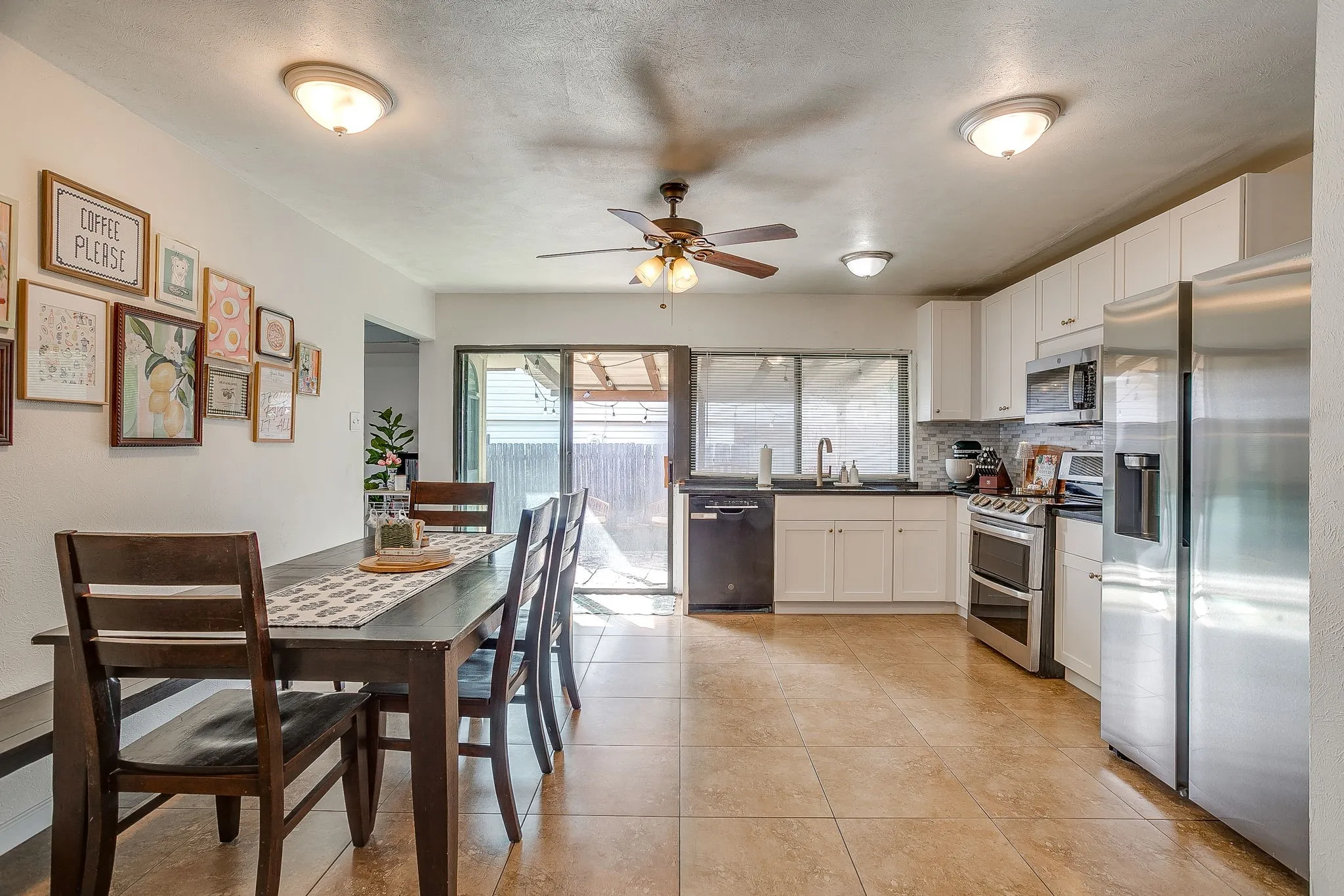 Large updated kitchen with stainless steel appliances, granite counters, and fresh backsplash.