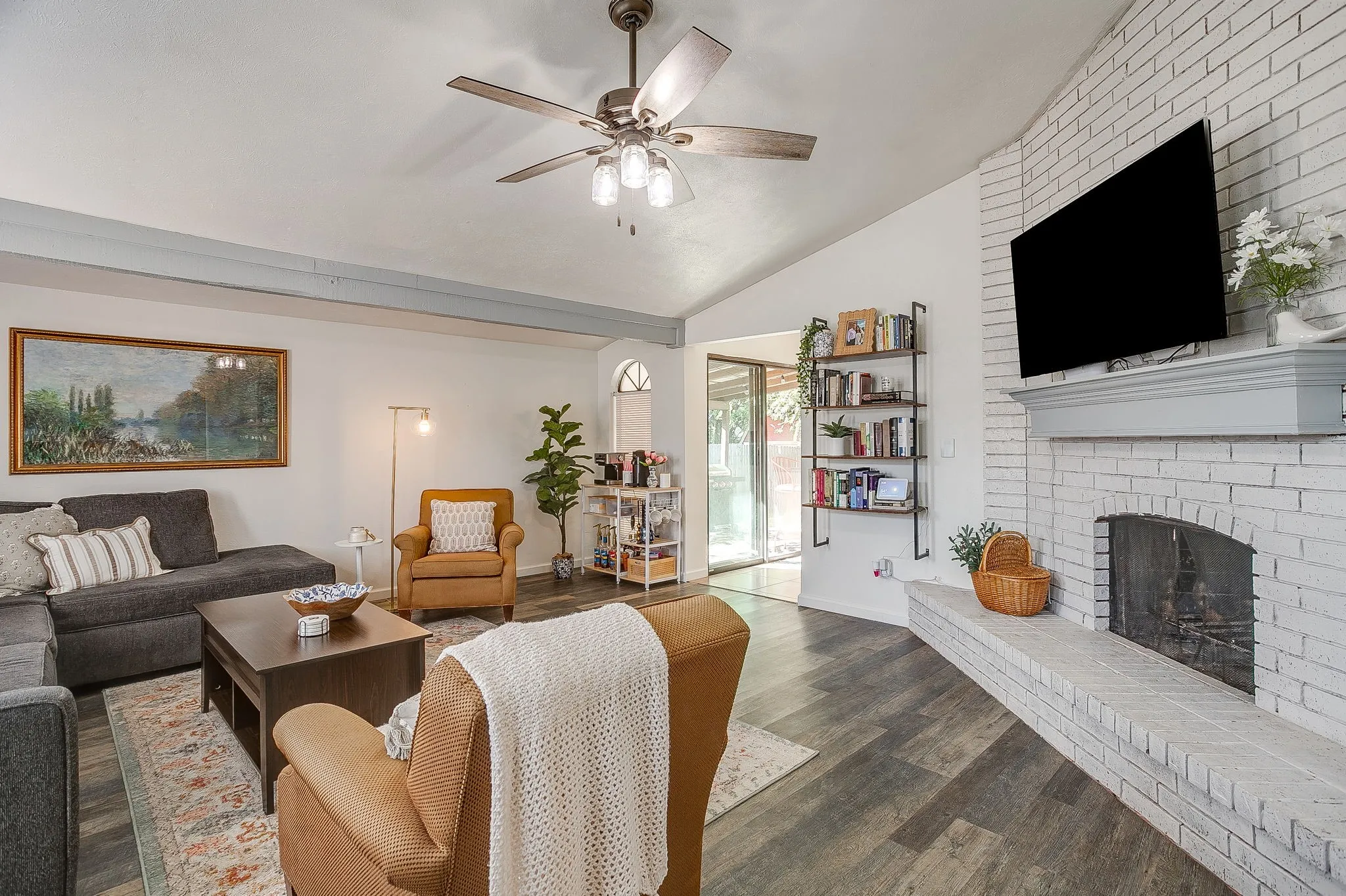 Large living space with extended hearth and wood burning fireplace.