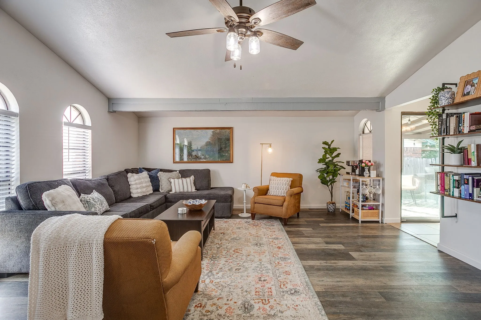 Lovely light and bright living room with vaulted ceiling, fresh paint, and laminate flooring.
