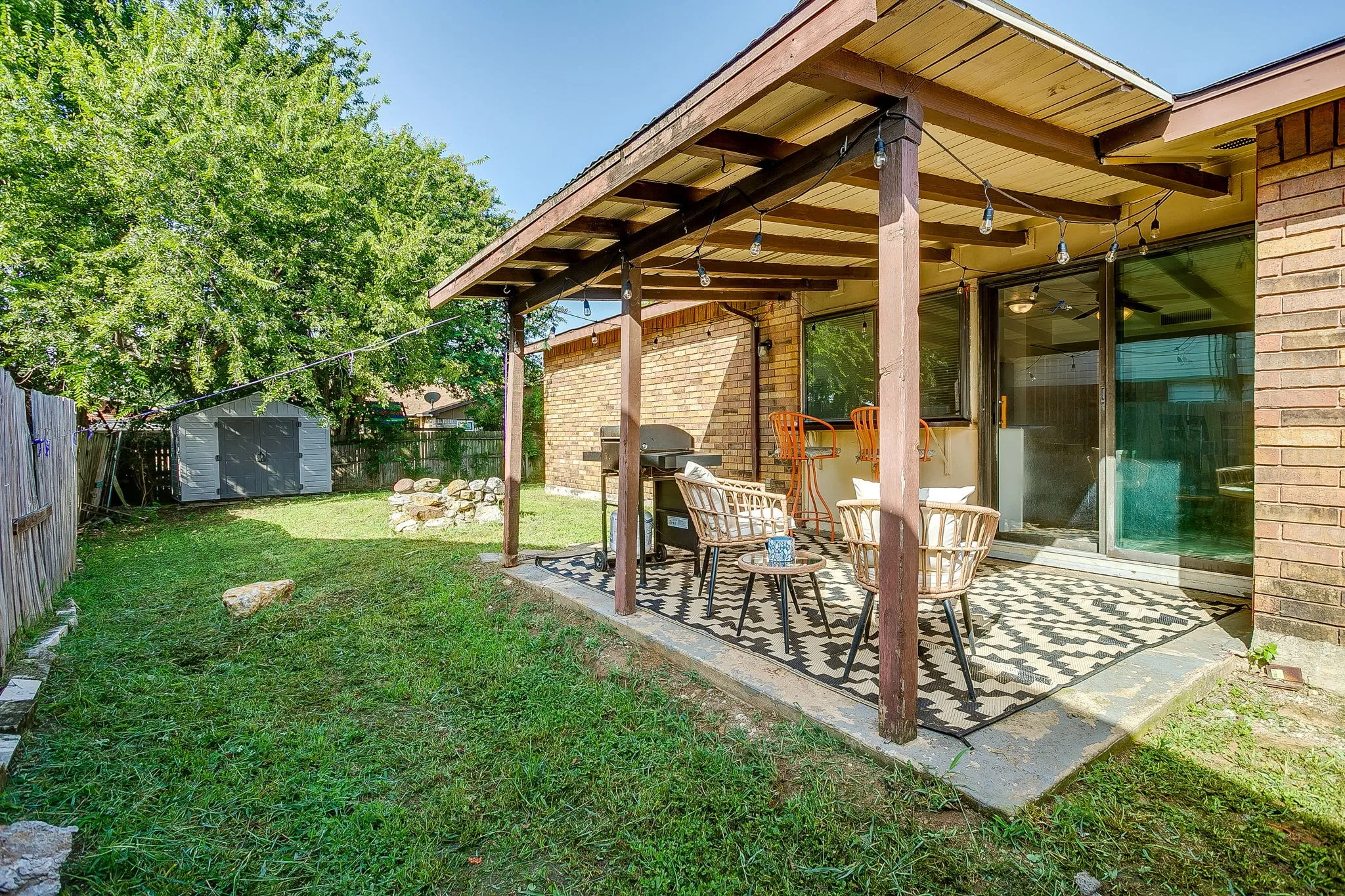 Covered patio on the backside of the home with sliding door to the kitchen for easy access.