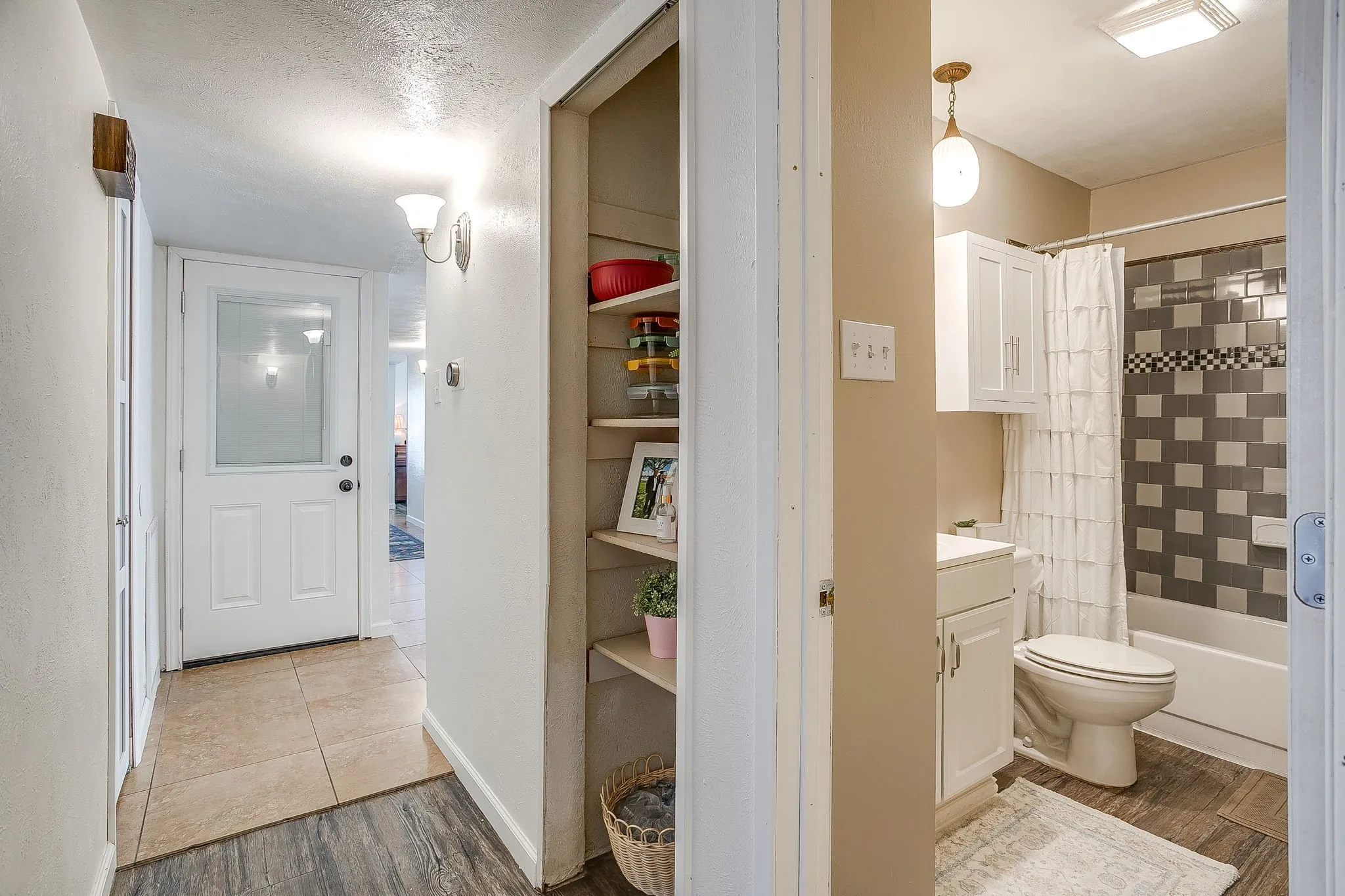 Hallway additional storage closets with shelving for additional storage or decorative space.