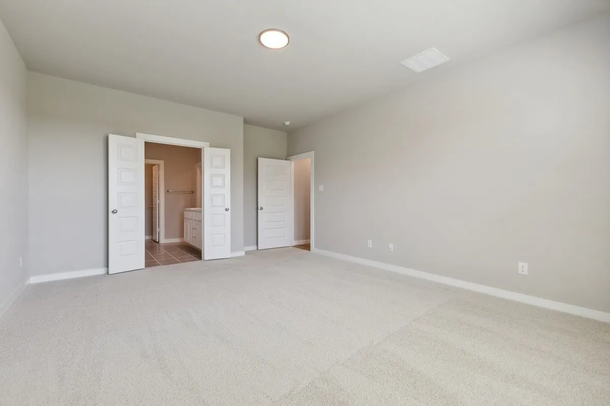 Primary Suite in the Masters home plan by Trophy Signature Homes – REPRESENTATIVE PHOTO