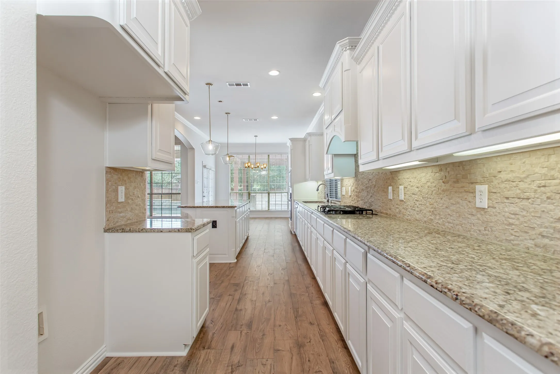 No shortage of storage in this large kitchen with many cabinets and a walk-in pantry