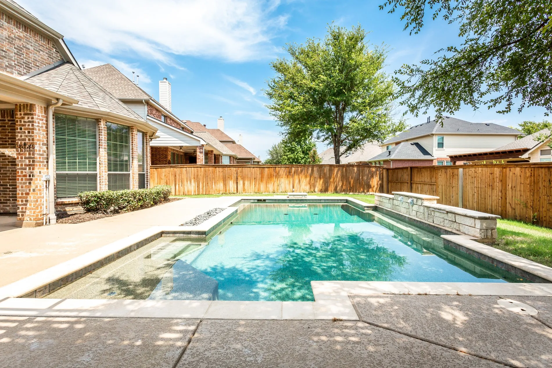 Large sparkling swimming pool with water feature