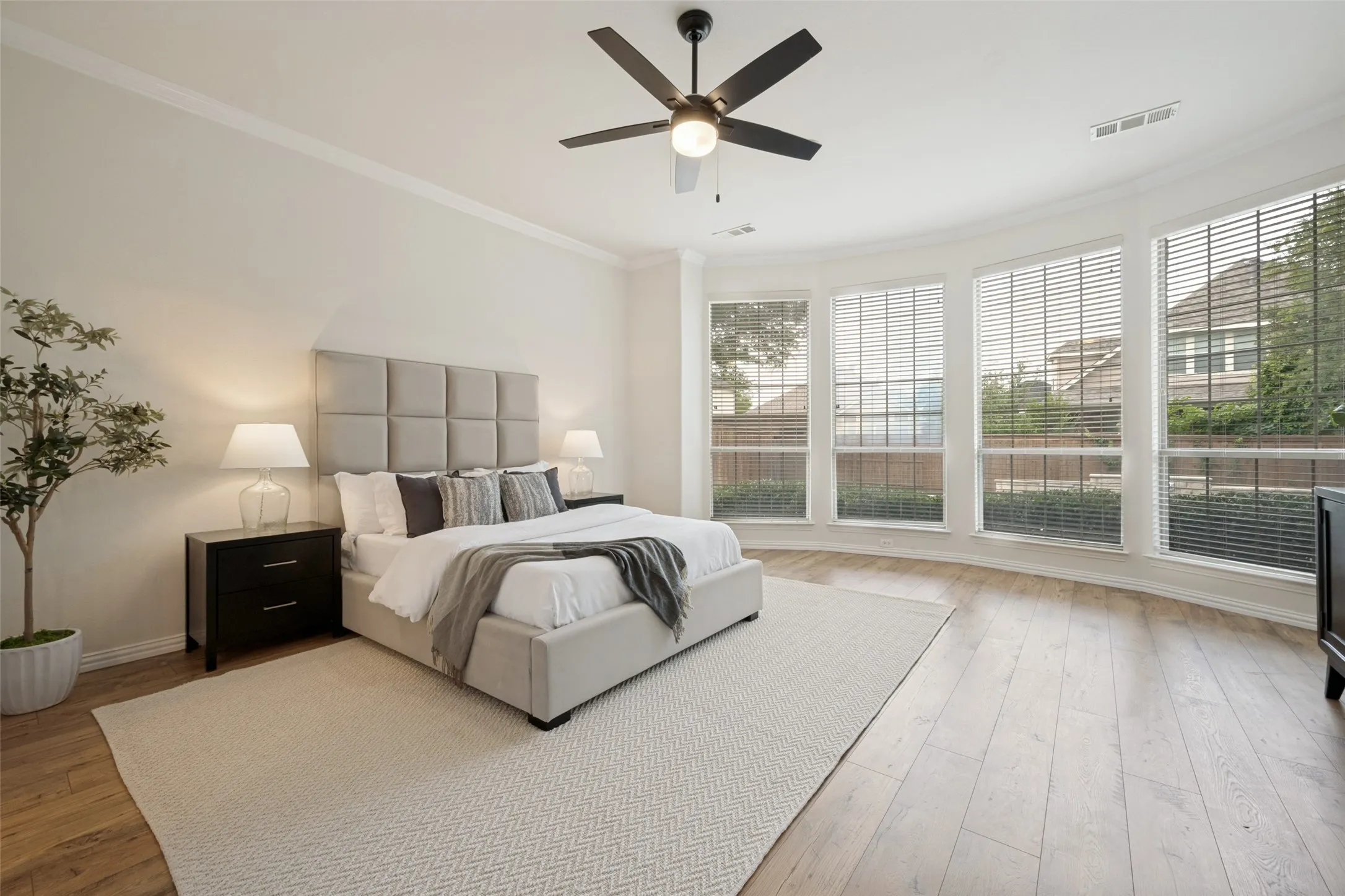 Large Master bedroom with bayed picture windows overlooking the beautiful backyard