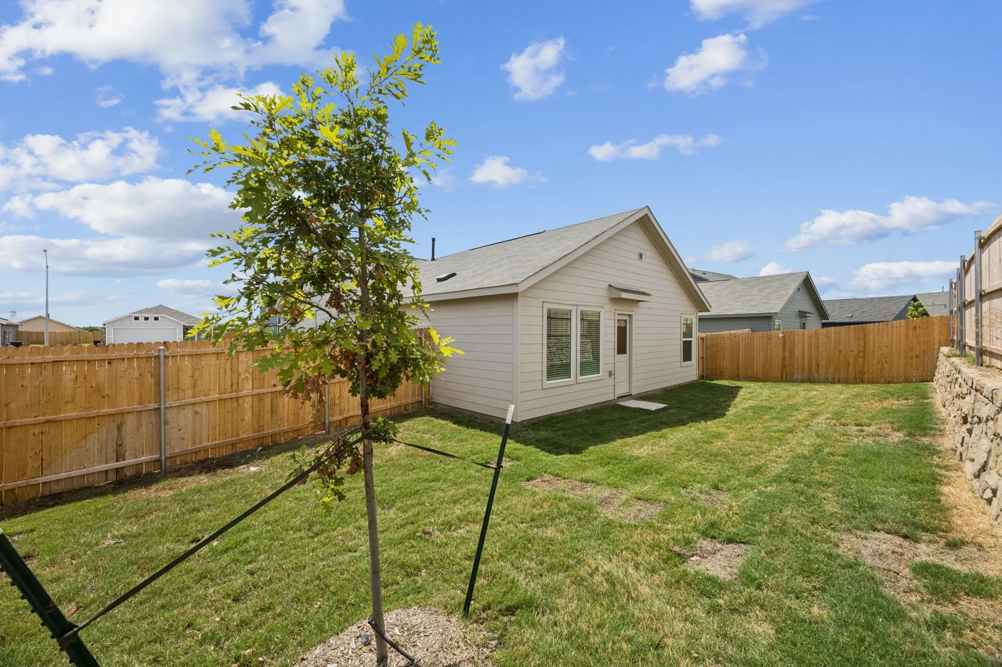 Back of house featuring a fenced backyard