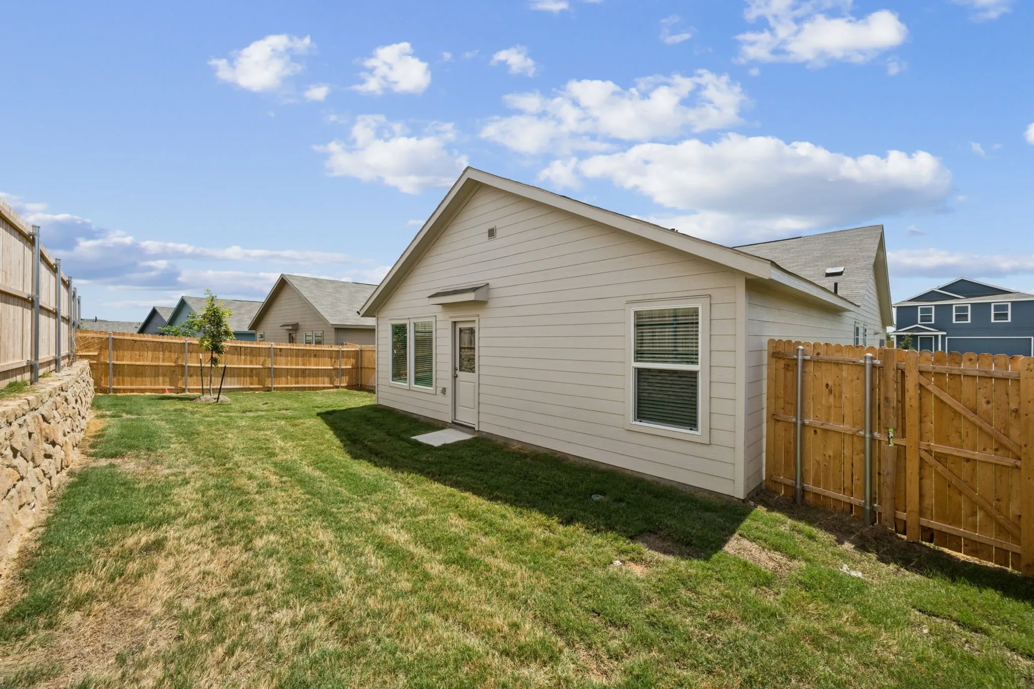 Back of house featuring a fenced backyard
