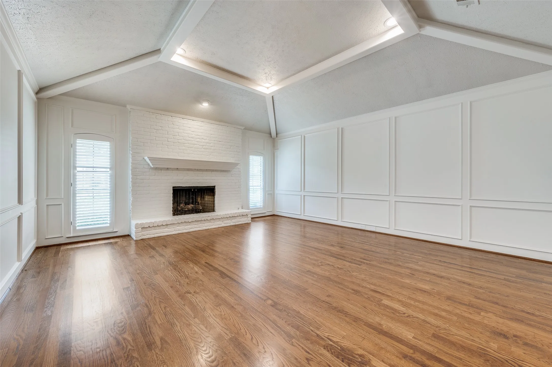 Living room with fireplace and vaulted ceiling
