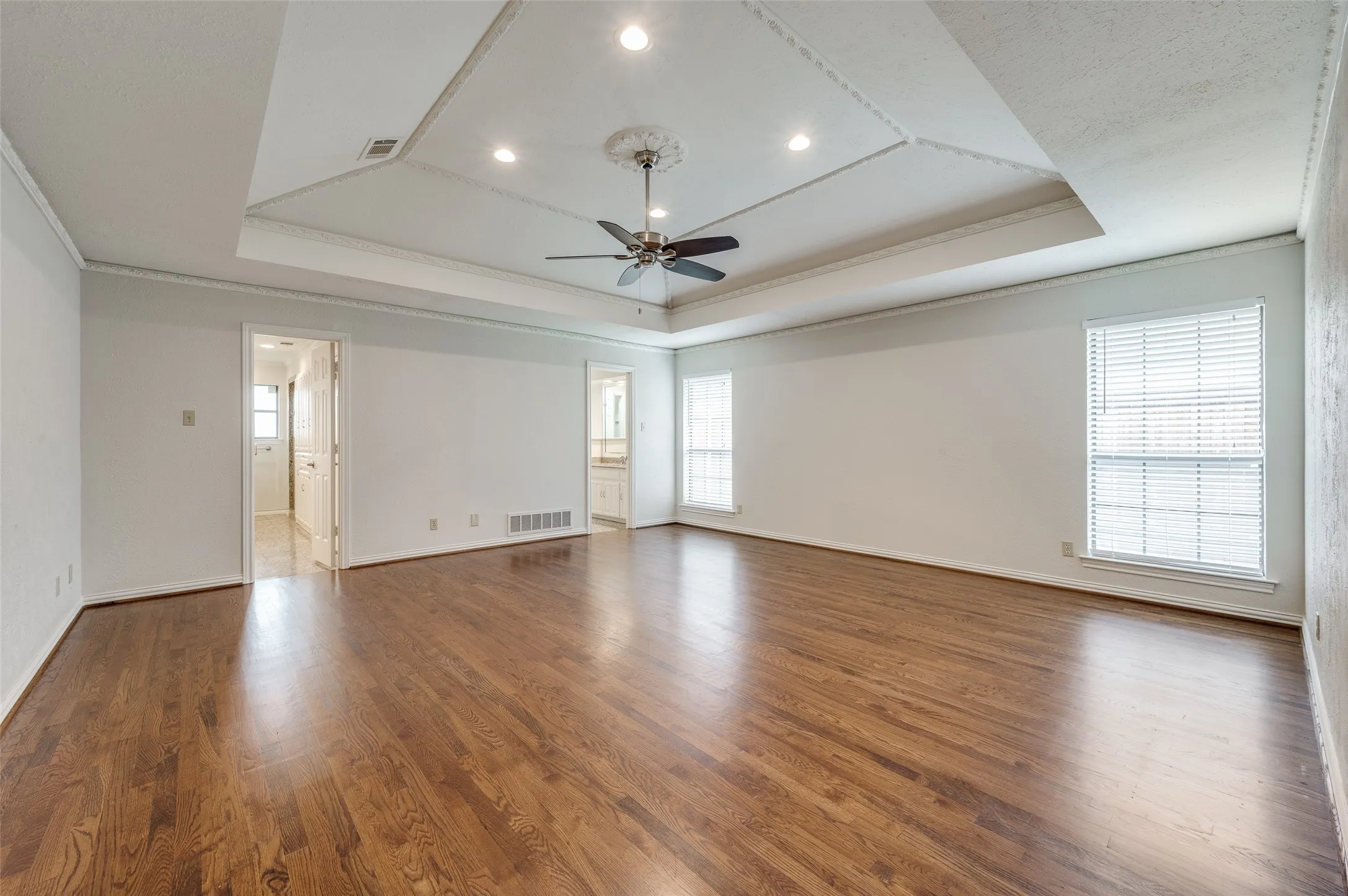 Primary bedroom with entrances to separate his and hers bath areas